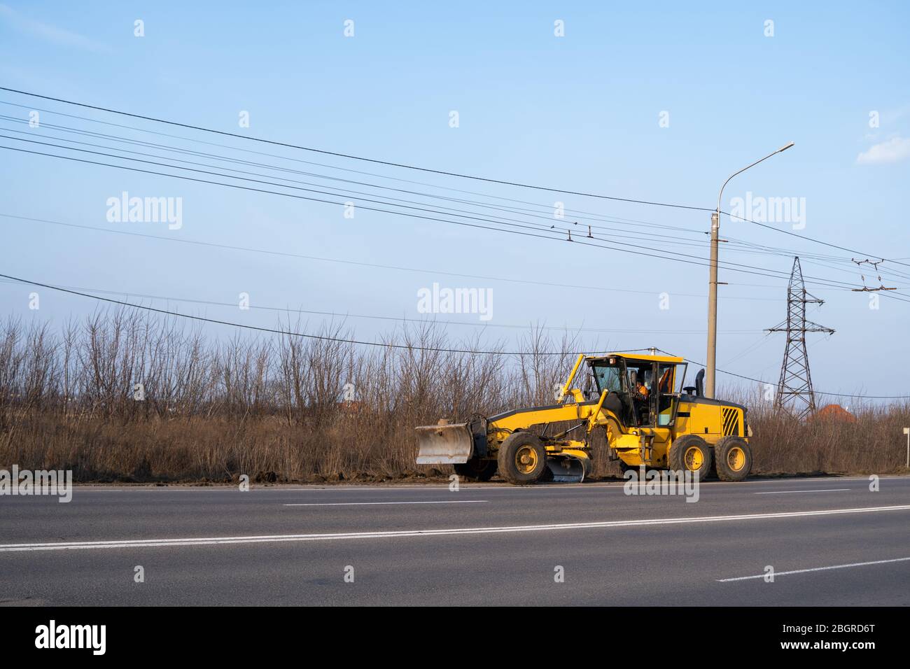 Grader is working on road construction. Grader industrial machine on