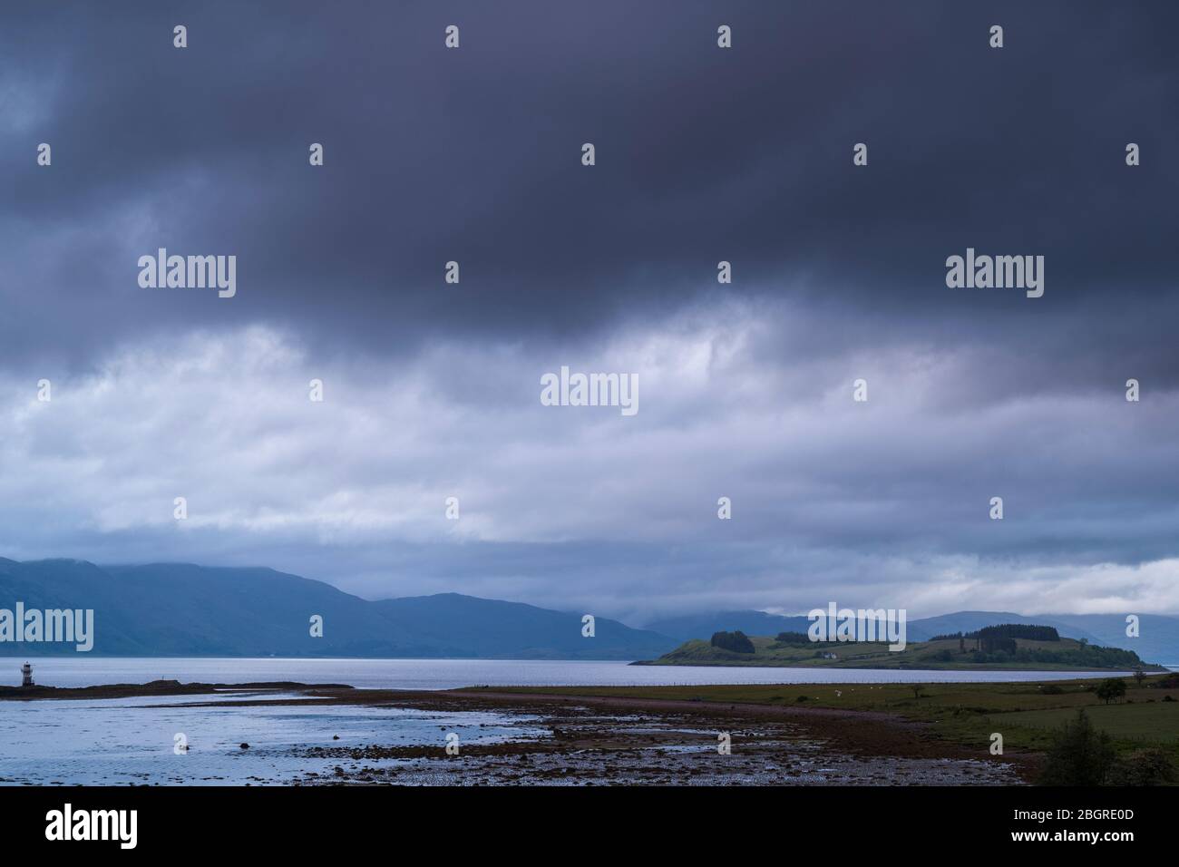 Heavy cloud over tranquil Scottish landscape, Argyllshire coast, Western Scotland Stock Photo