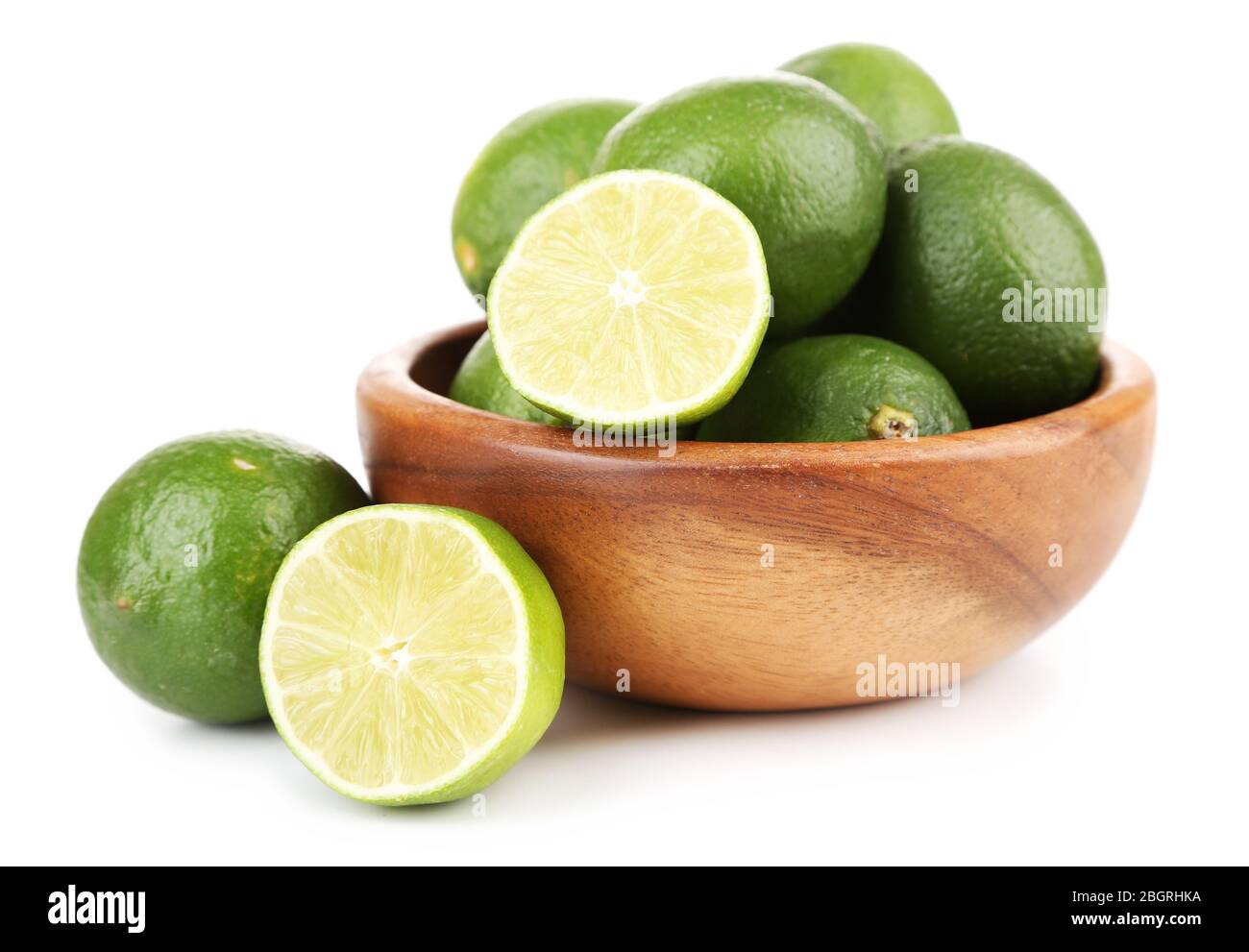 Fresh Juicy Limes In Wooden Bowl, Isolated On White Stock Photo - Alamy