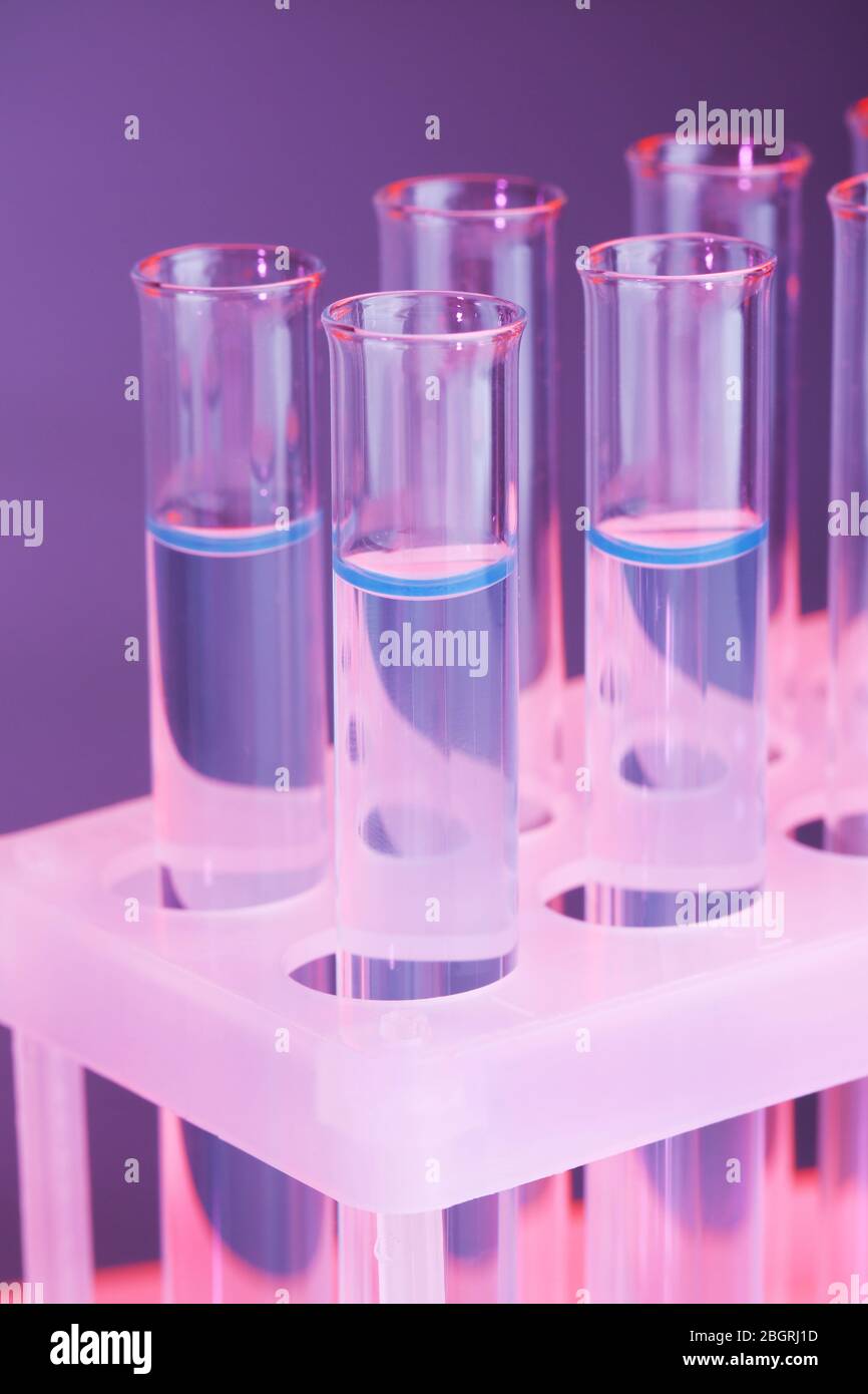 Test-tubes with blue liquid on dark blue background Stock Photo - Alamy