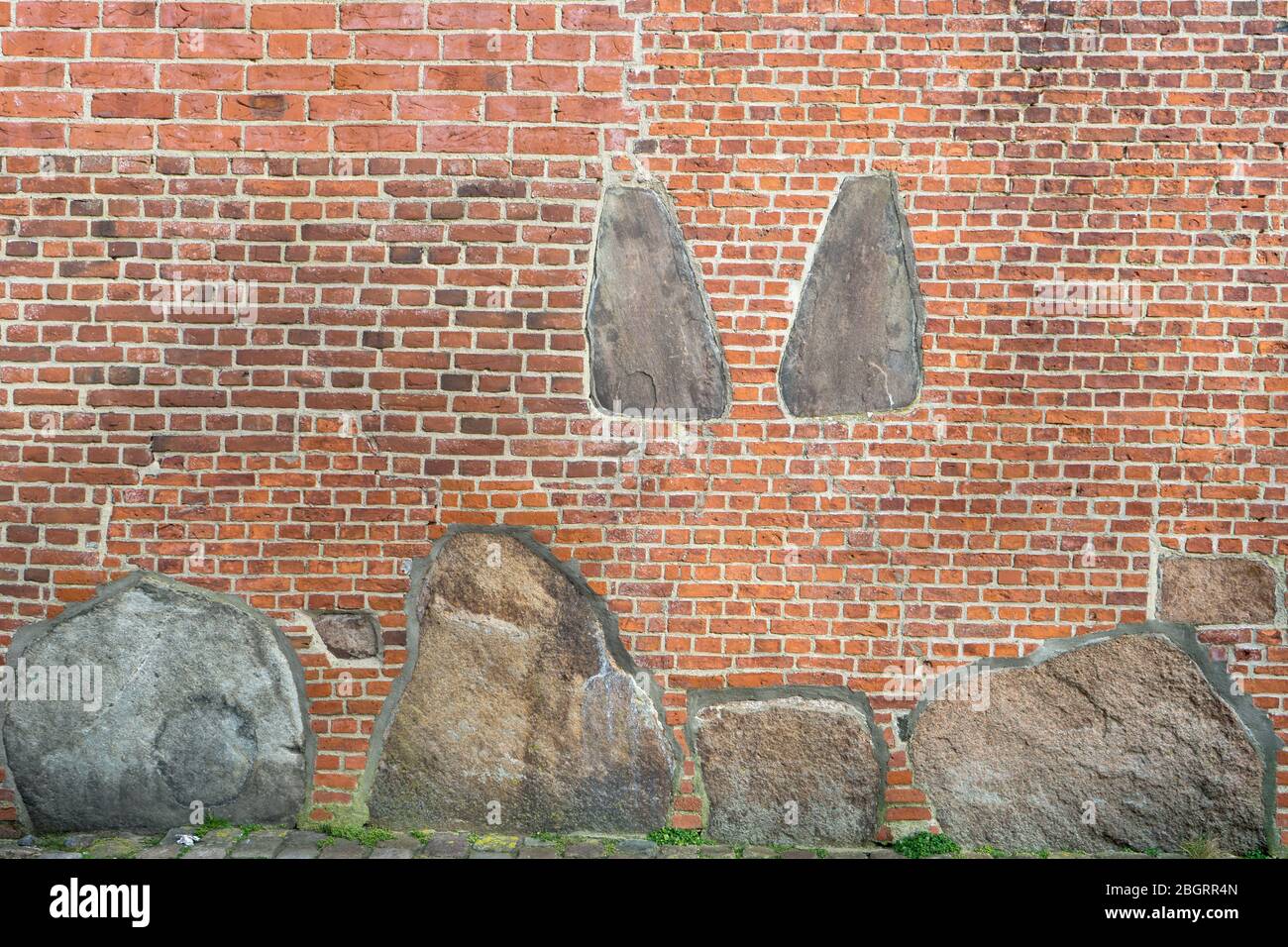 Wall of the St. Severin church in Keitum on the island of Sylt with the two tombstones of the sisters Ing and Dung Stock Photo