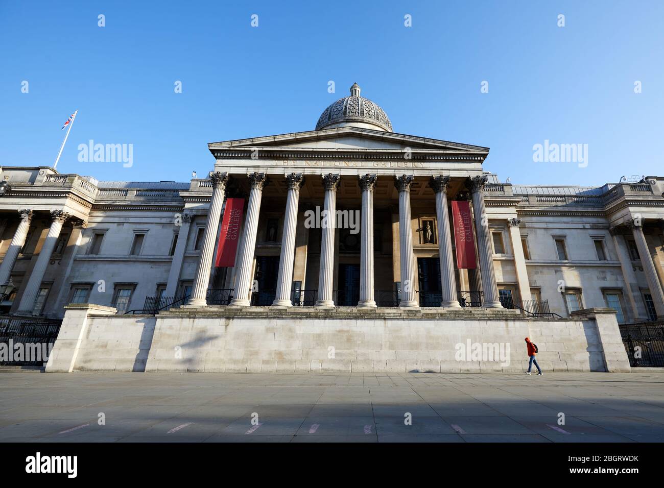London, U.K. - 22 Apr 2020: A man walks past the National Gallery, deserted during the coronavirus lockdown. Stock Photo