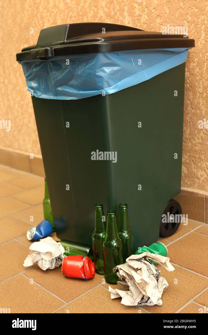 Recycling bin on wall background Stock Photo - Alamy