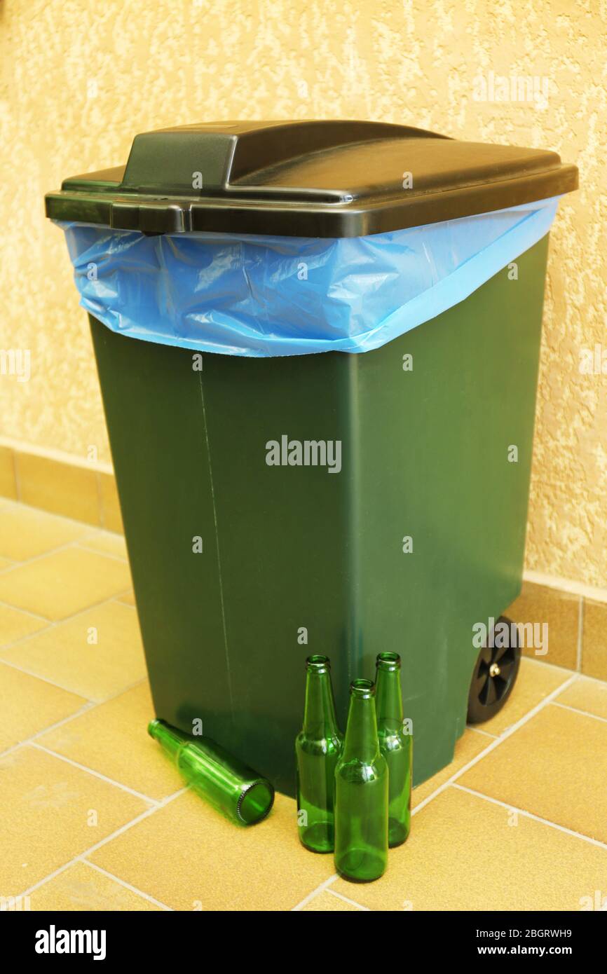 Recycling bin on wall background Stock Photo - Alamy