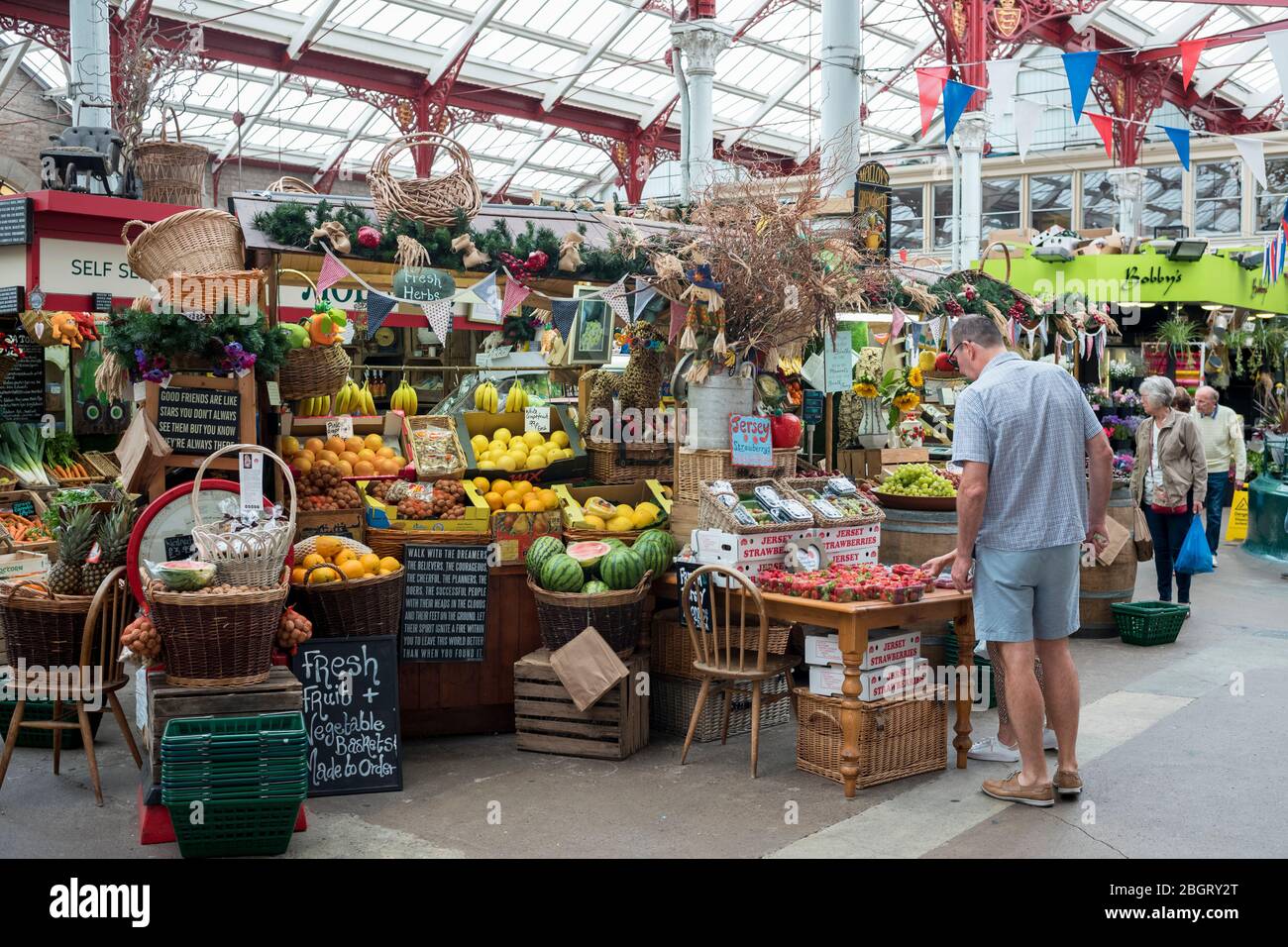 Fruit and other items on sale at St Helier Central Market in historic Victorian market hall, in Jersey, Channel Isles Stock Photo