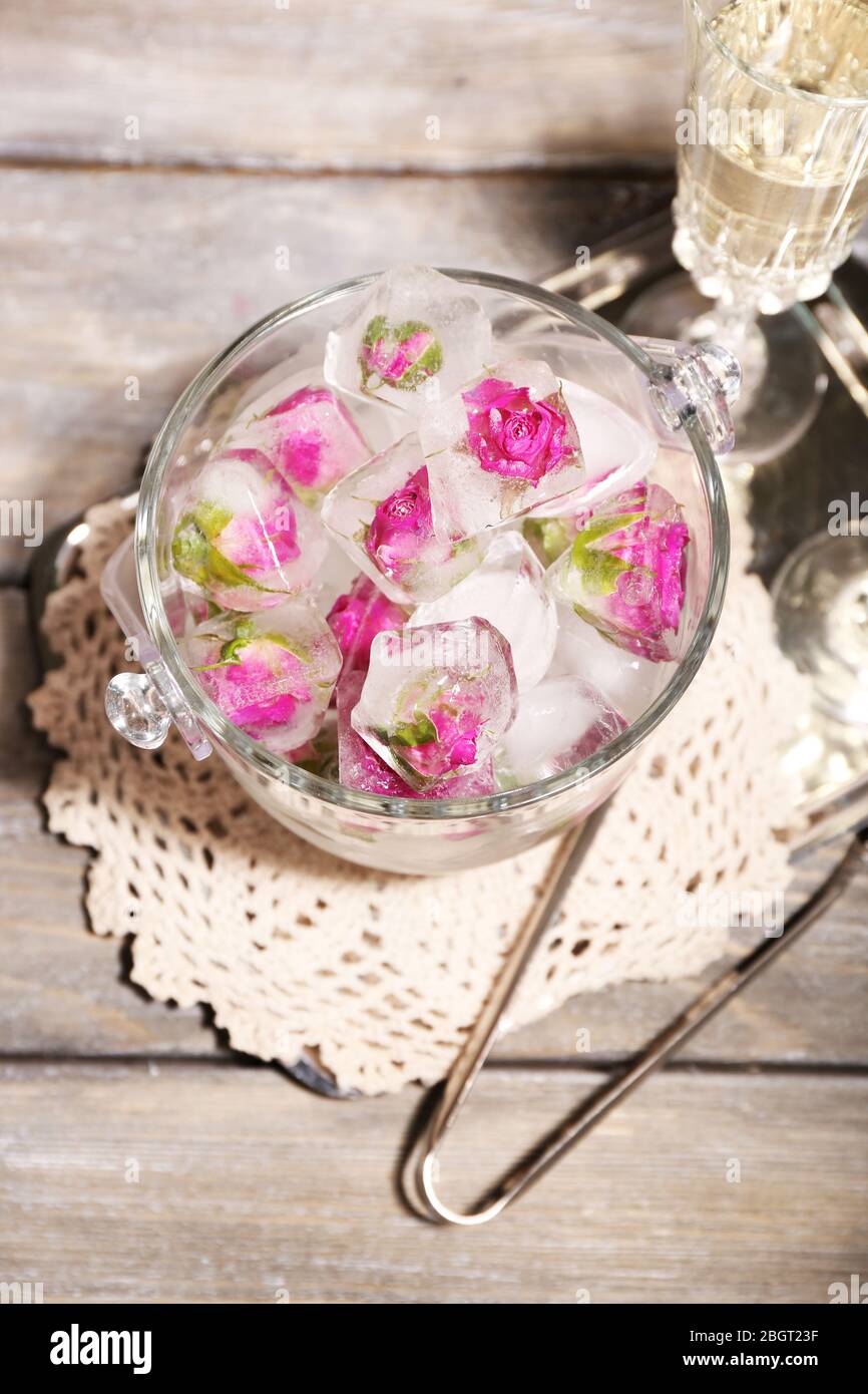 Ice Cubes With Rose Flowers In Glass Bucket And Two Glasses With Champagne On Wooden Table Background Stock Photo Alamy