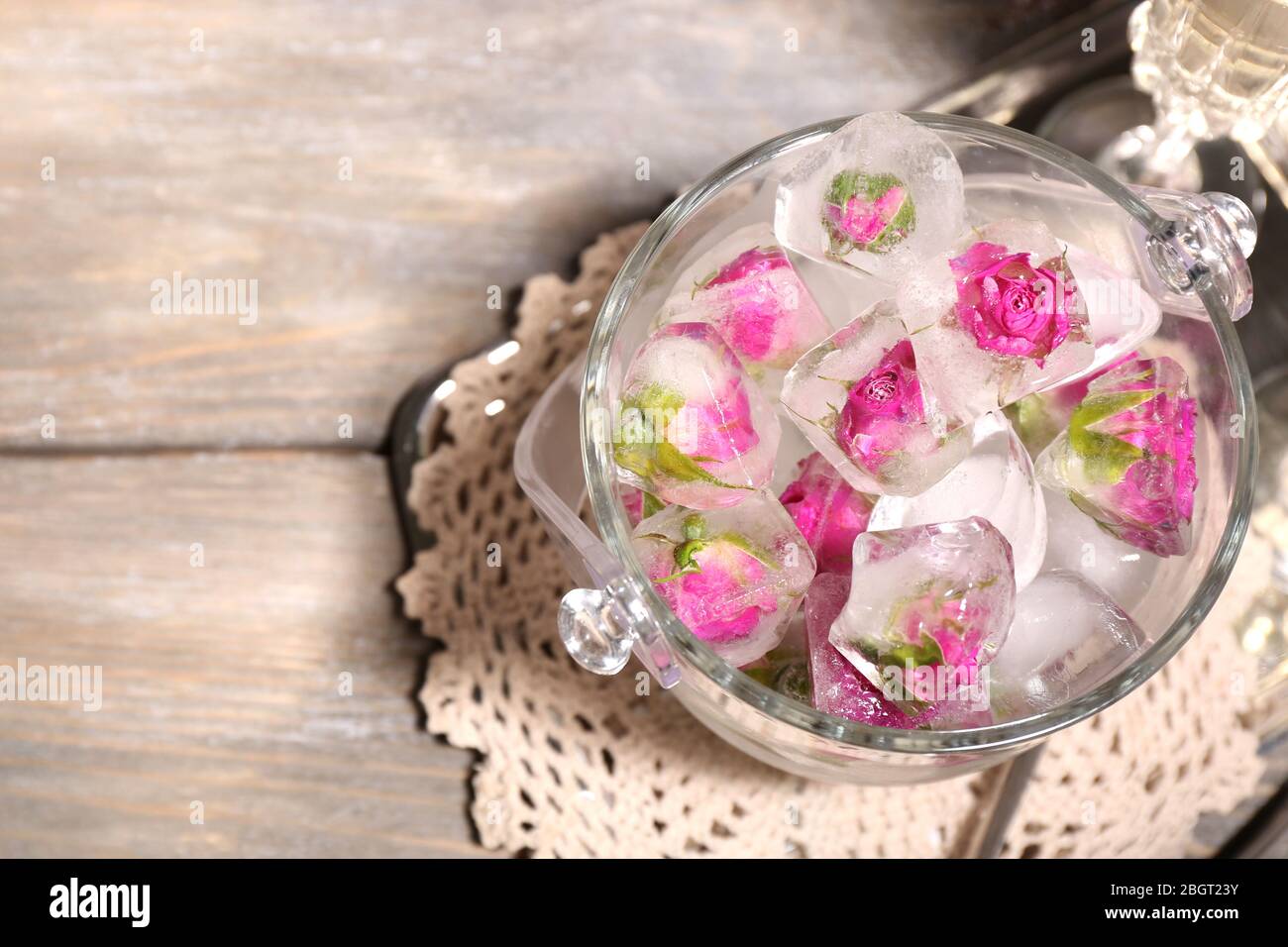 Ice Cubes With Rose Flowers In Glass Bucket And Two Glasses With Champagne On Wooden Table Background Stock Photo Alamy