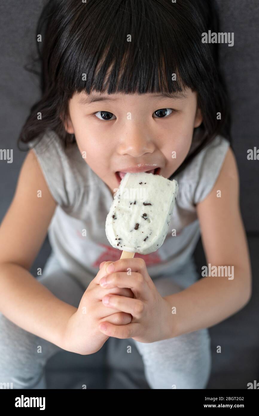 Cute toddler girl eating ice cream Stock Photo Alamy