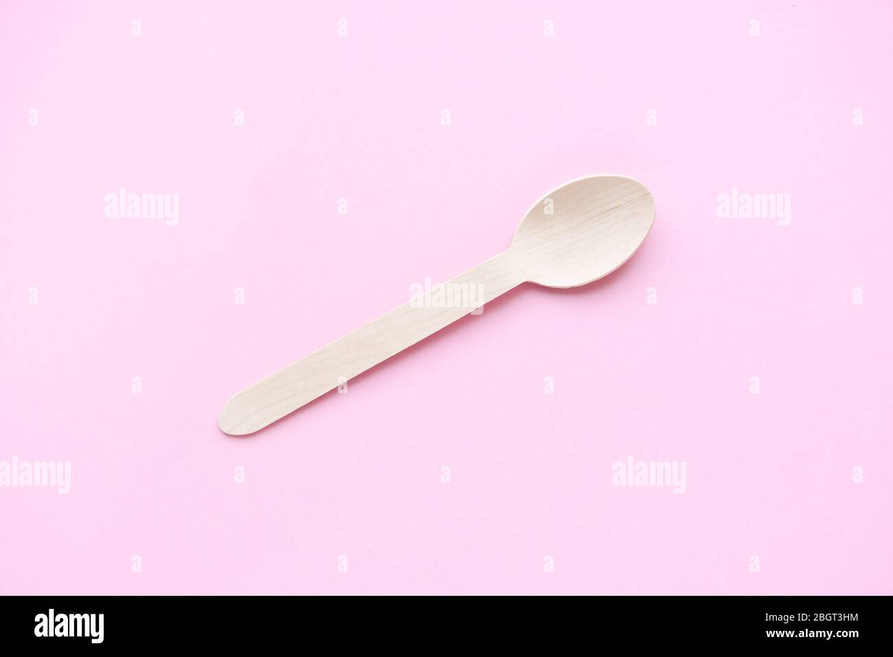eco friendly disposable kitchenware utensils on pink background. wooden