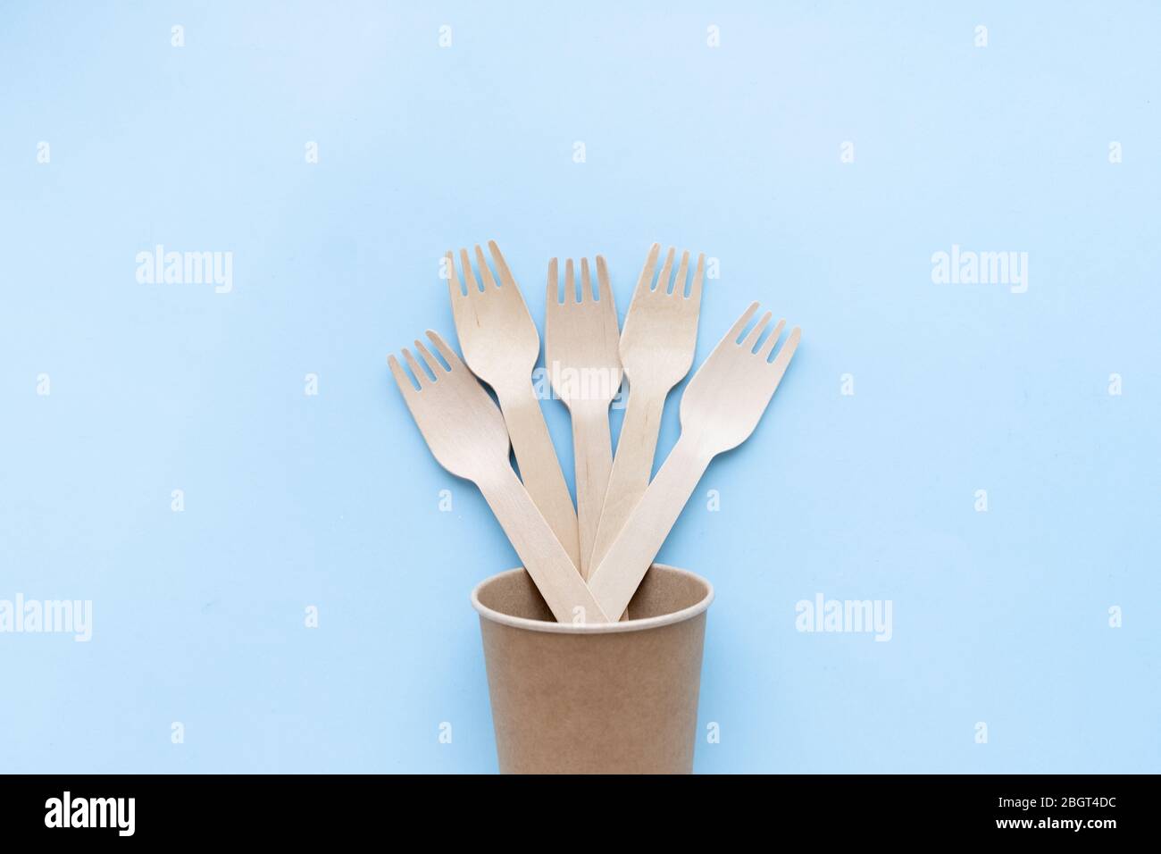 eco friendly disposable kitchenware utensils on blue background. wooden