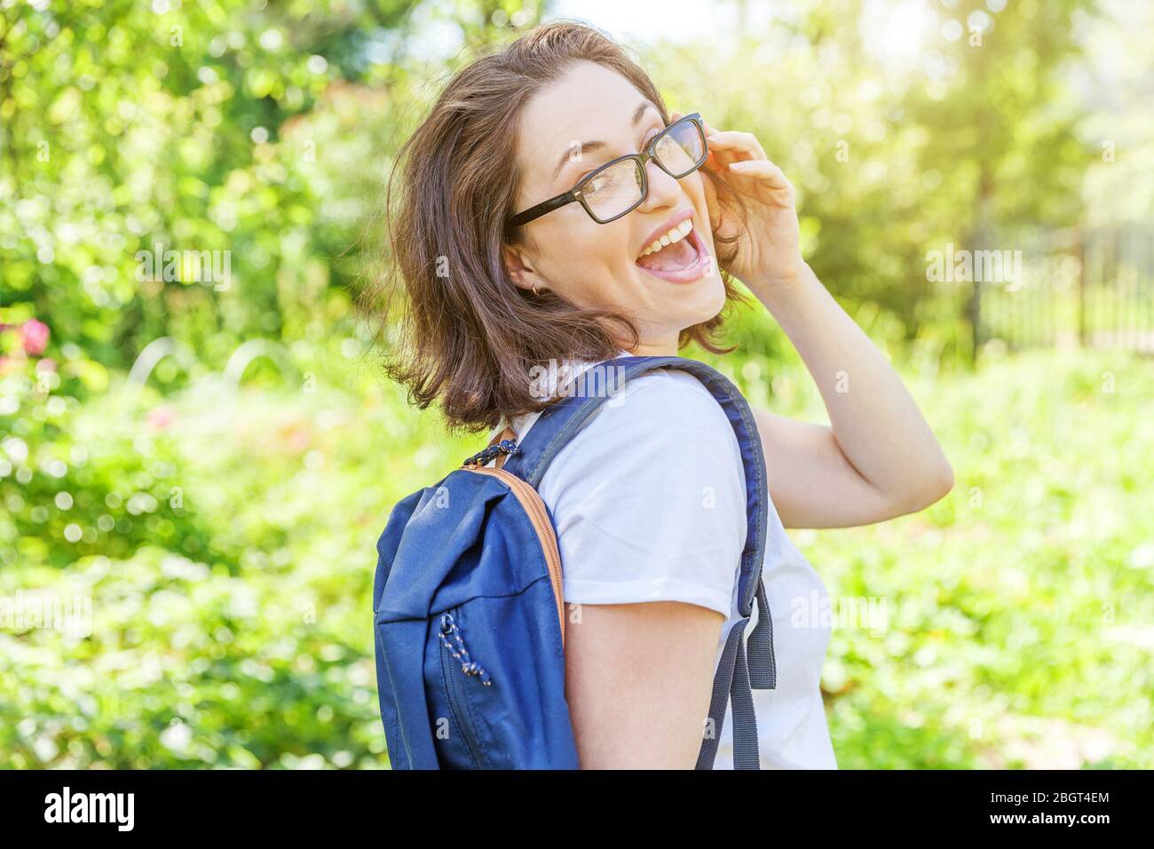 Positive Rested Students Happy beautiful positive student girl in eyeglasses with backpack ...
