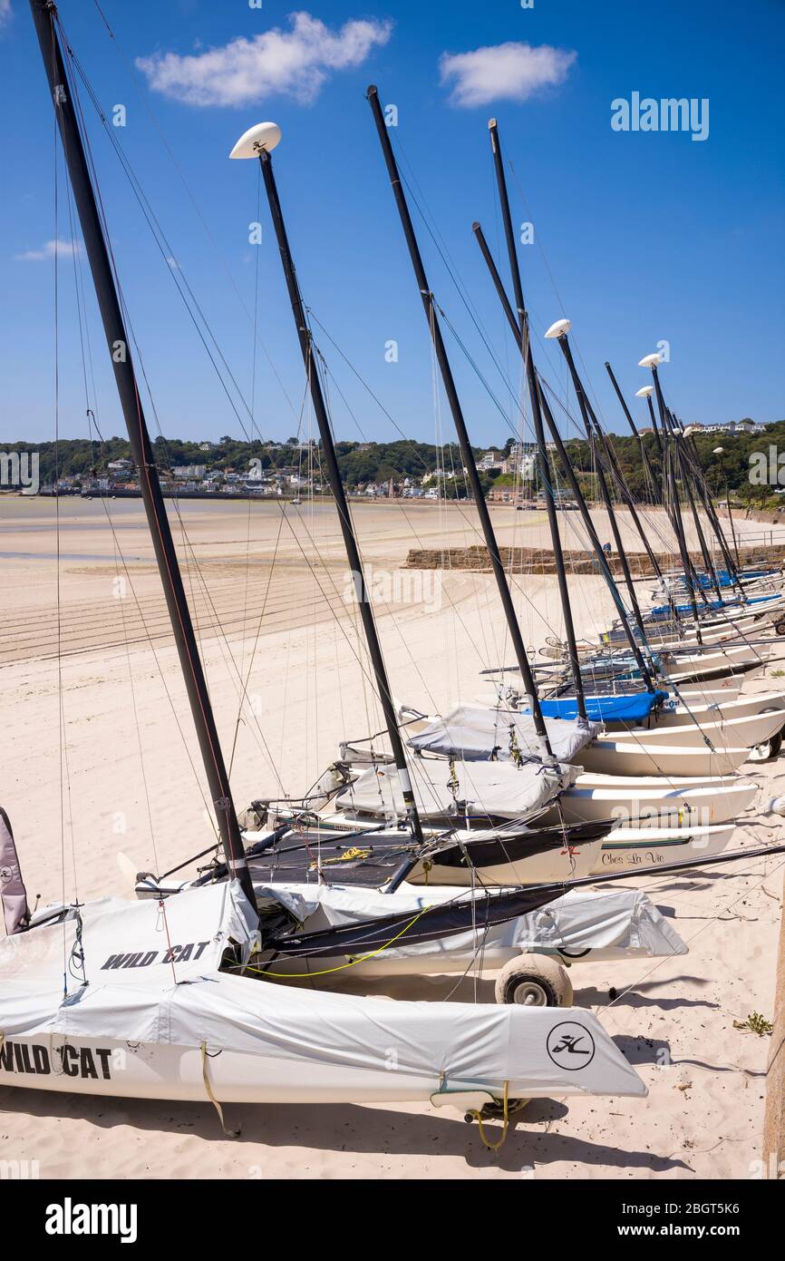 Row of catamarans on St Aubin's sandy beach, Jersey, Channel Isles Stock Photo