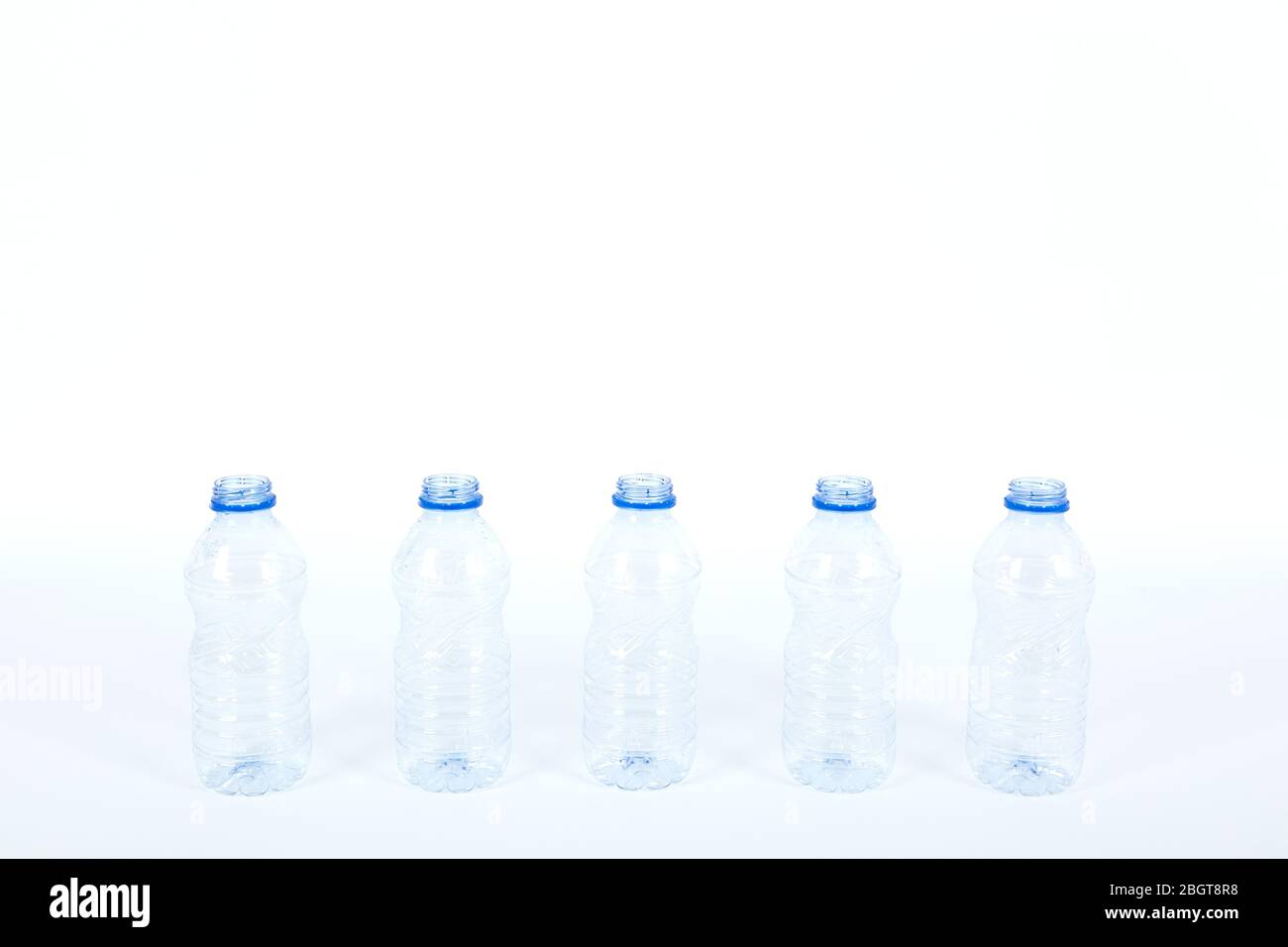 row of plastic bottles for recycling on a white background Stock Photo ...