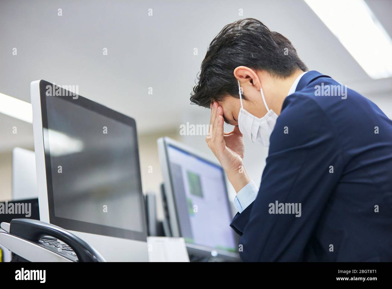 Tired Japanese businessman in the office Stock Photo - Alamy