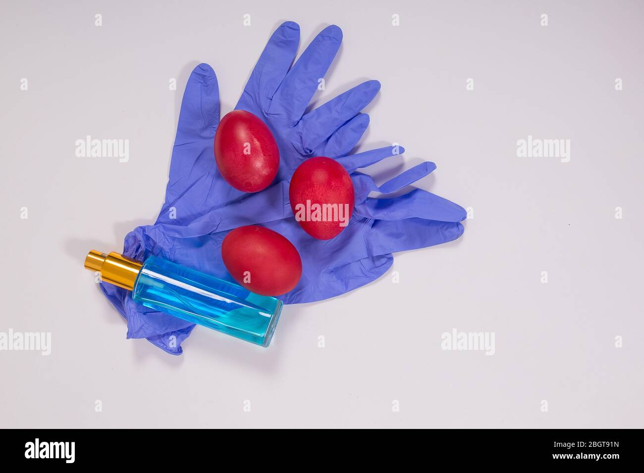 Easter in gloves. The family shares Easter eggs in protective gloves and a mask. Coronavirus, Quarantine, Pandemic Stock Photo