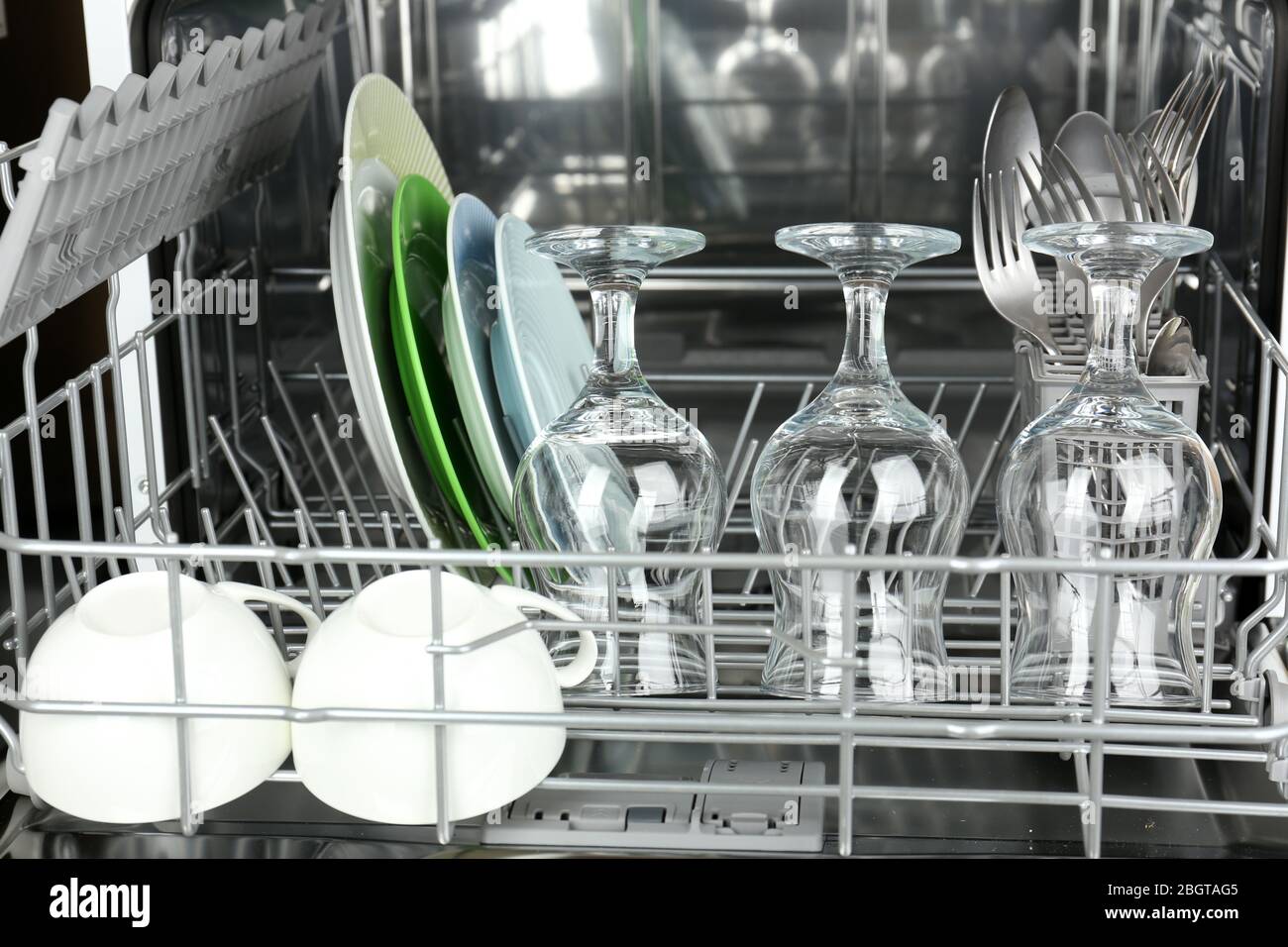 Open dishwasher with clean utensils in it Stock Photo Alamy