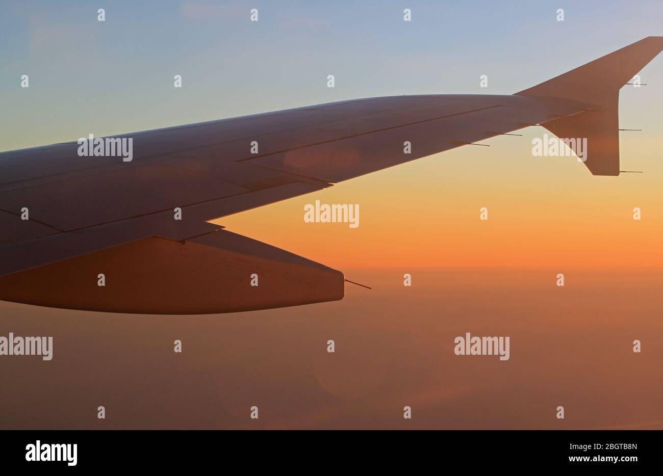 Airplane wing on the sky background. Sofia, Bulgaria - April 30, 2012: Passenger plane Airbus A320 flying to Beauvais airport Paris, France. Stock Photo