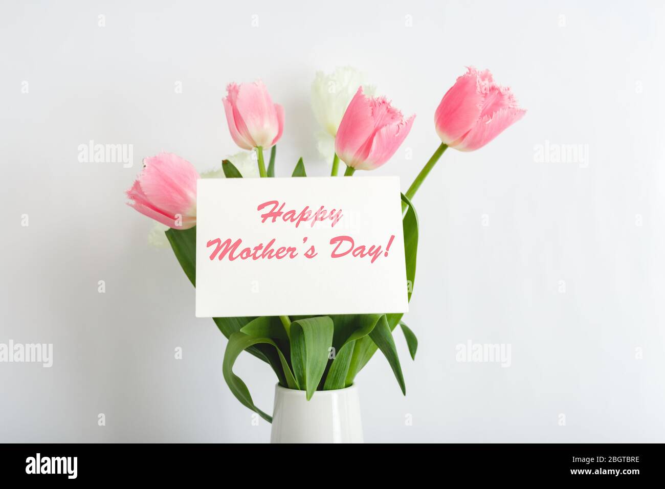 Happy Mothers Day text on gift card in flower bouquet on white ...