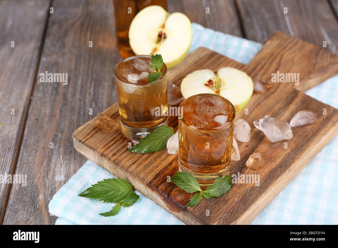 Still life with tasty apple cider in barrel and fresh apples Stock Photo