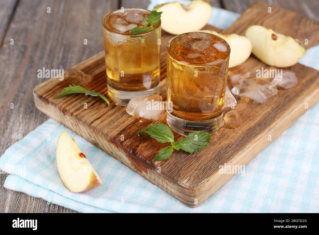 Still life with tasty apple cider in barrel and fresh apples Stock Photo
