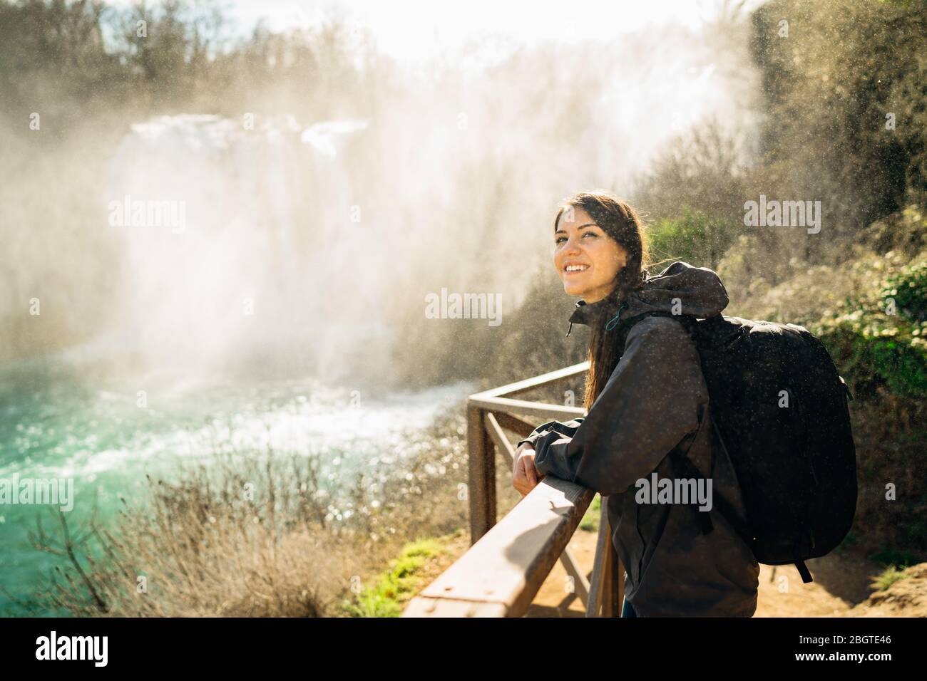 Woman tourist hiker visiting a mountain national park waterfall trail.Adventure tourist exploring nature.Nature and environment lover.Healthy lifestyl Stock Photo