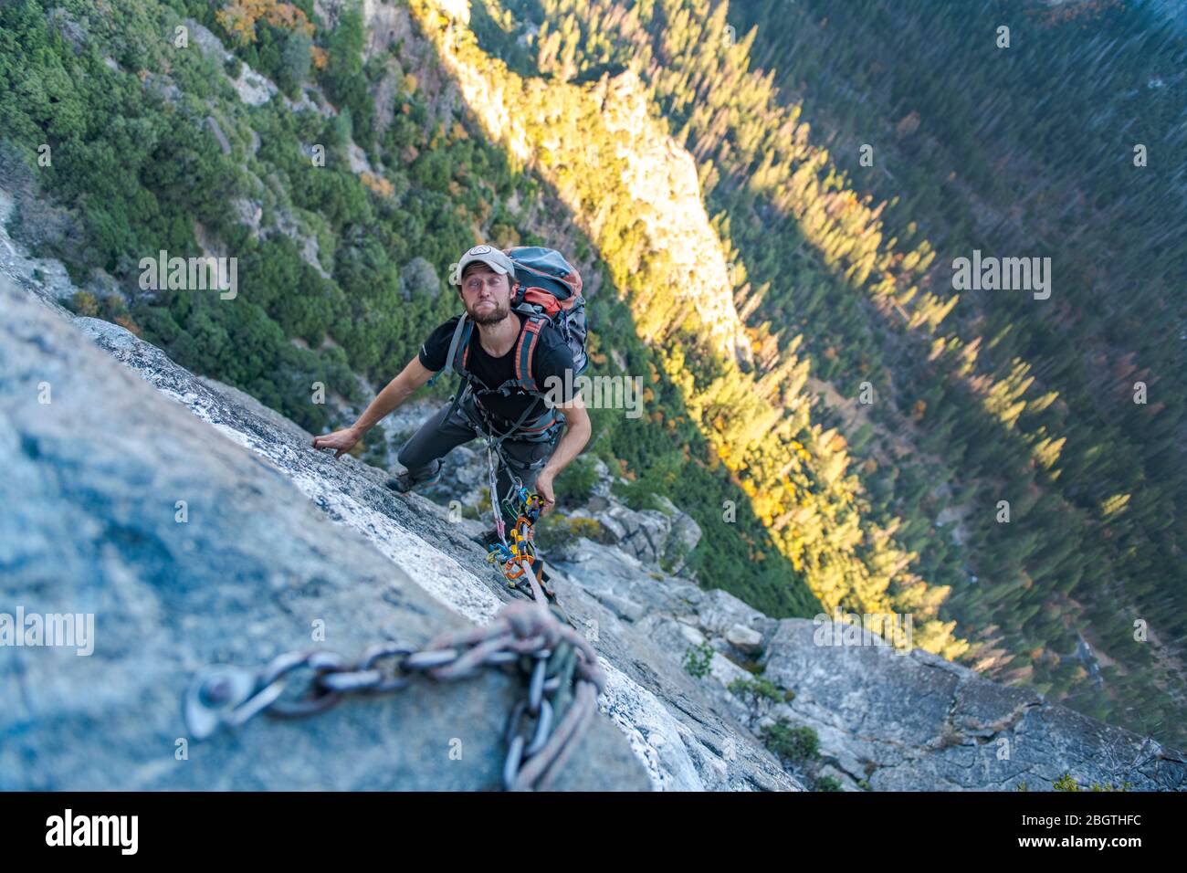 Man looking up doing funny face while jugging rope up El Capitan Stock Photo
