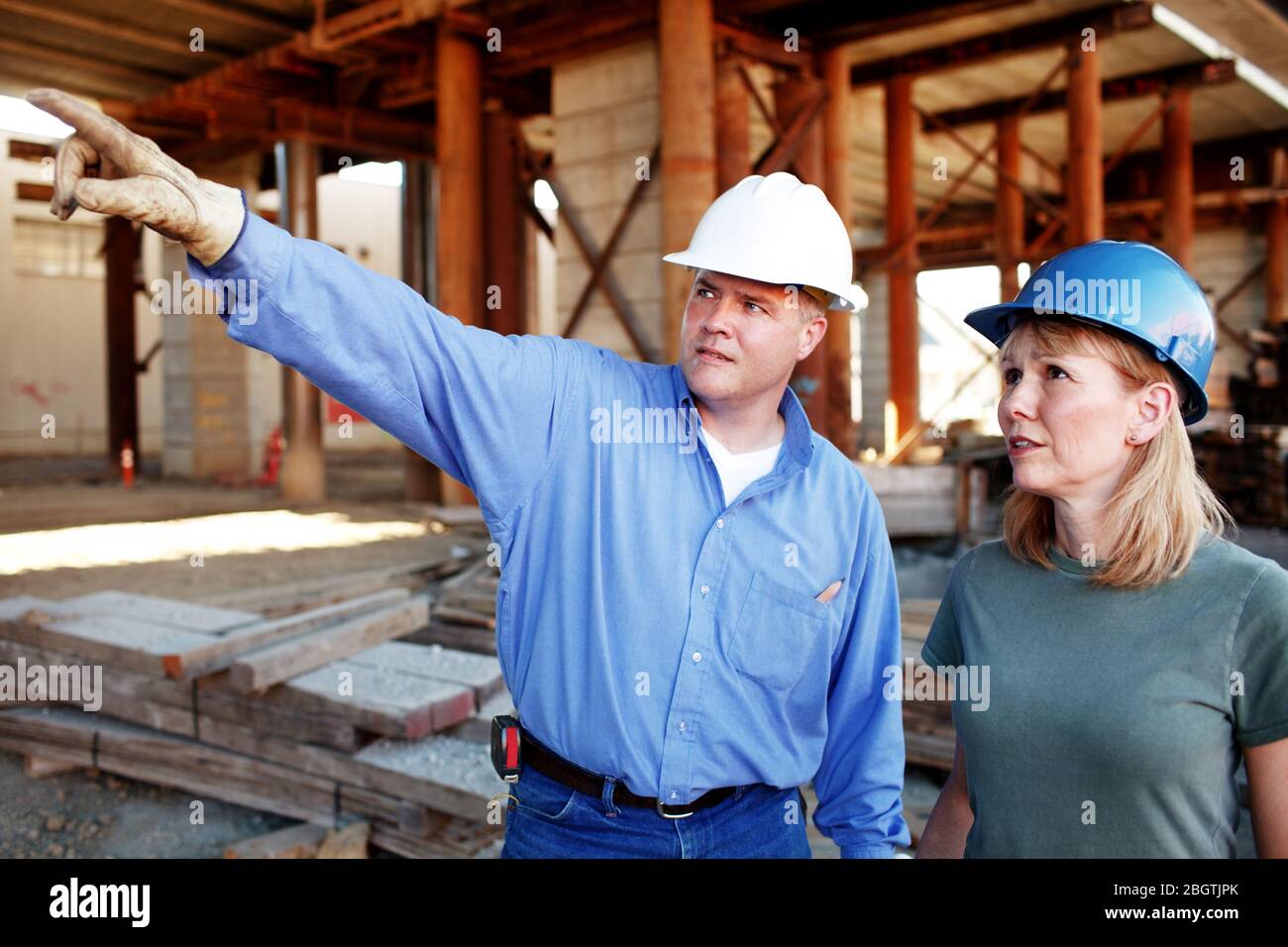 Male construction foreman giving directions to construction work Stock Photo