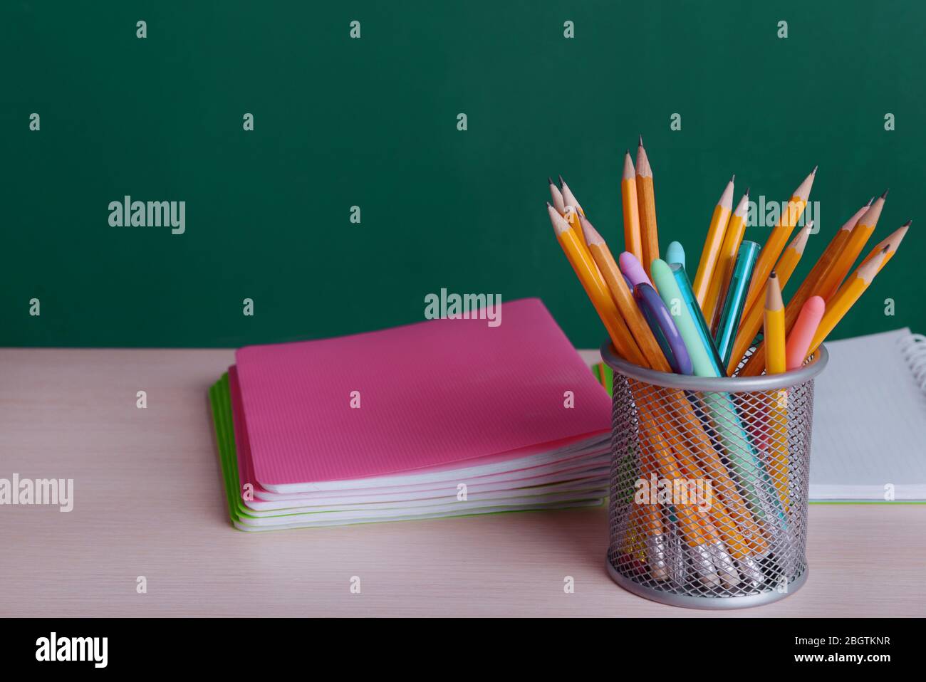 School supplies on table on board background Stock Photo
