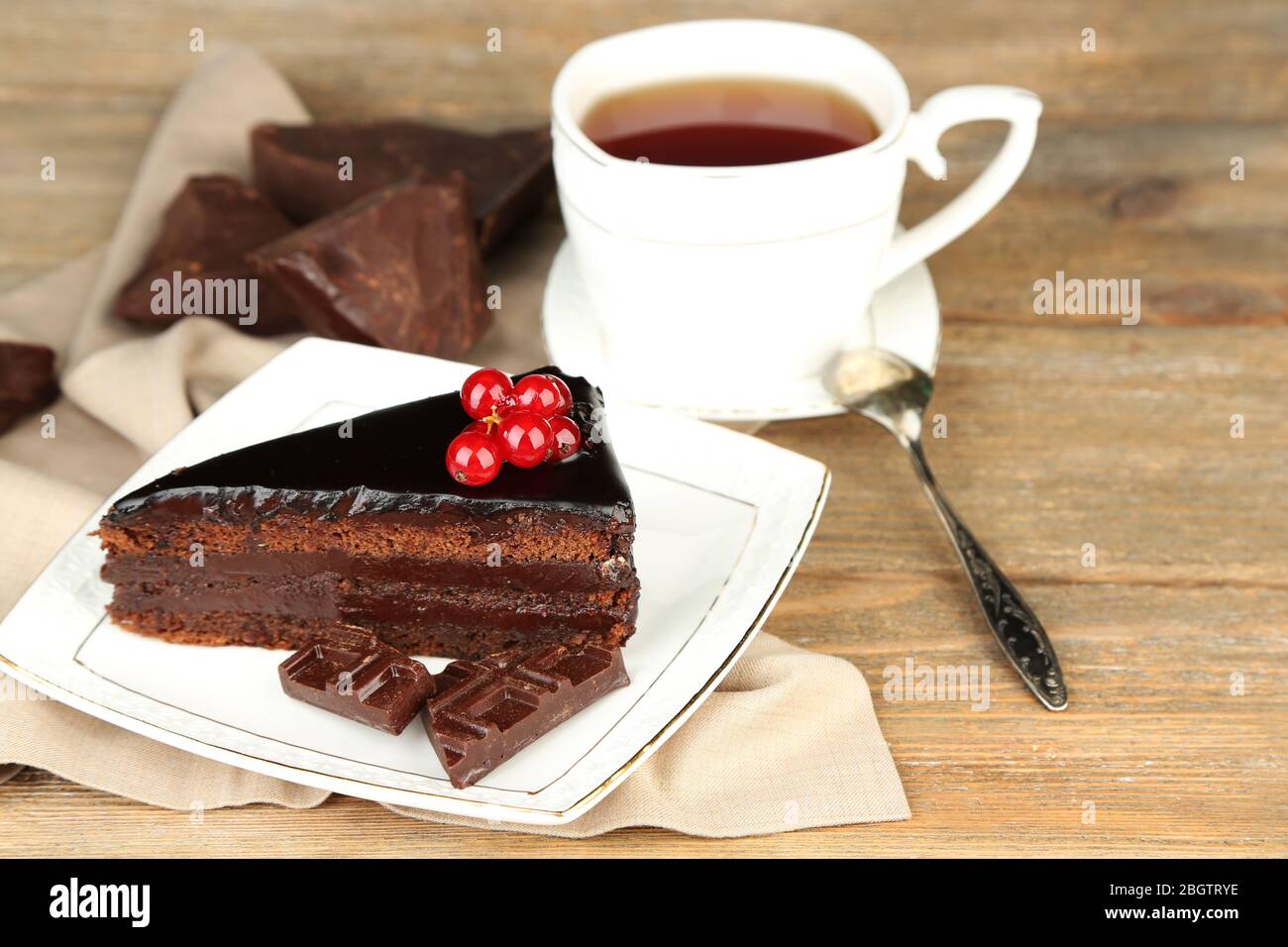 Chocolate cake with fresh berries on plate, on color wooden background ...