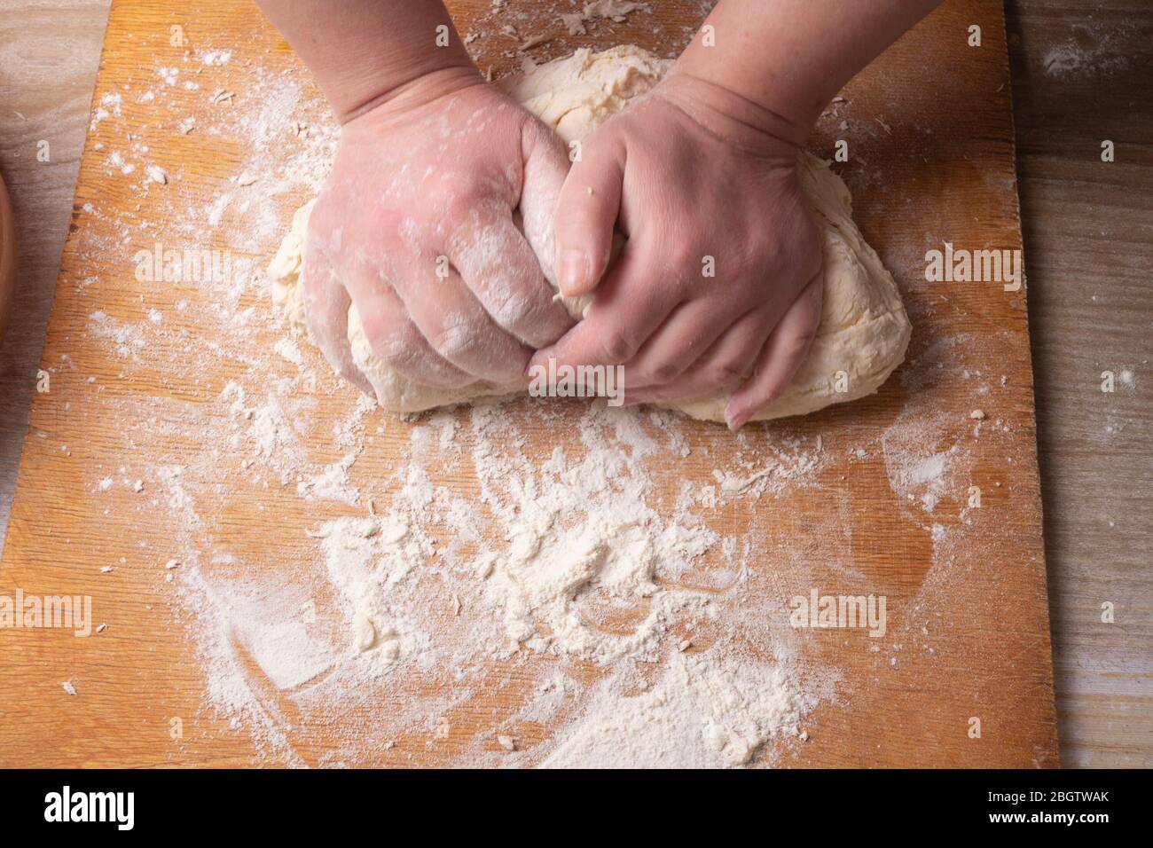 Female hands mixing dough in the home kitchen. Stock Photo
