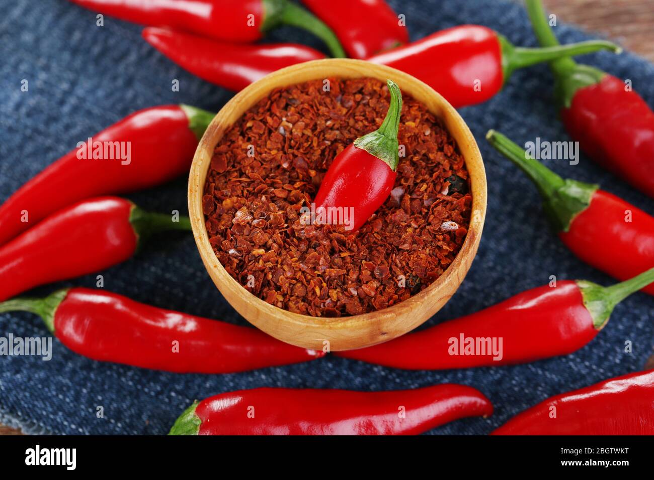 Red hot chili peppers on color fabric background Stock Photo - Alamy