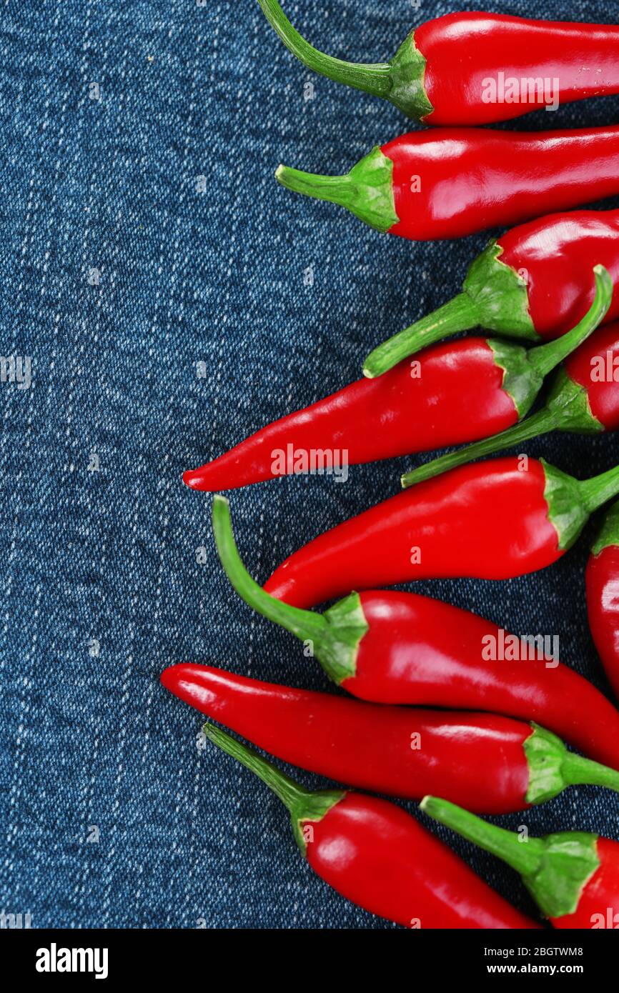Red hot chili peppers on color fabric background Stock Photo - Alamy