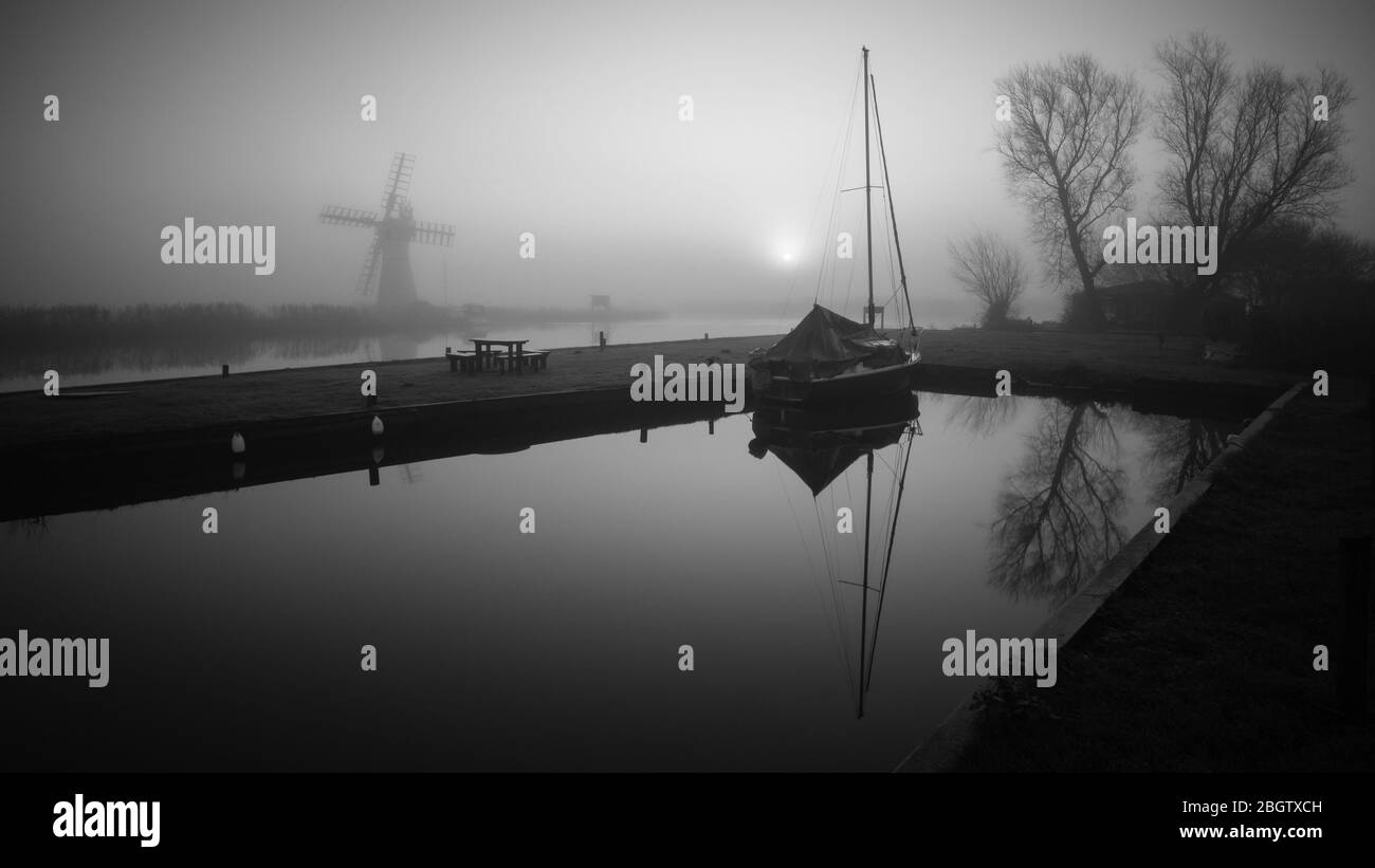 Mill in the mist with berthed sailboat, Mono- Thurne, December 2015 Stock Photo
