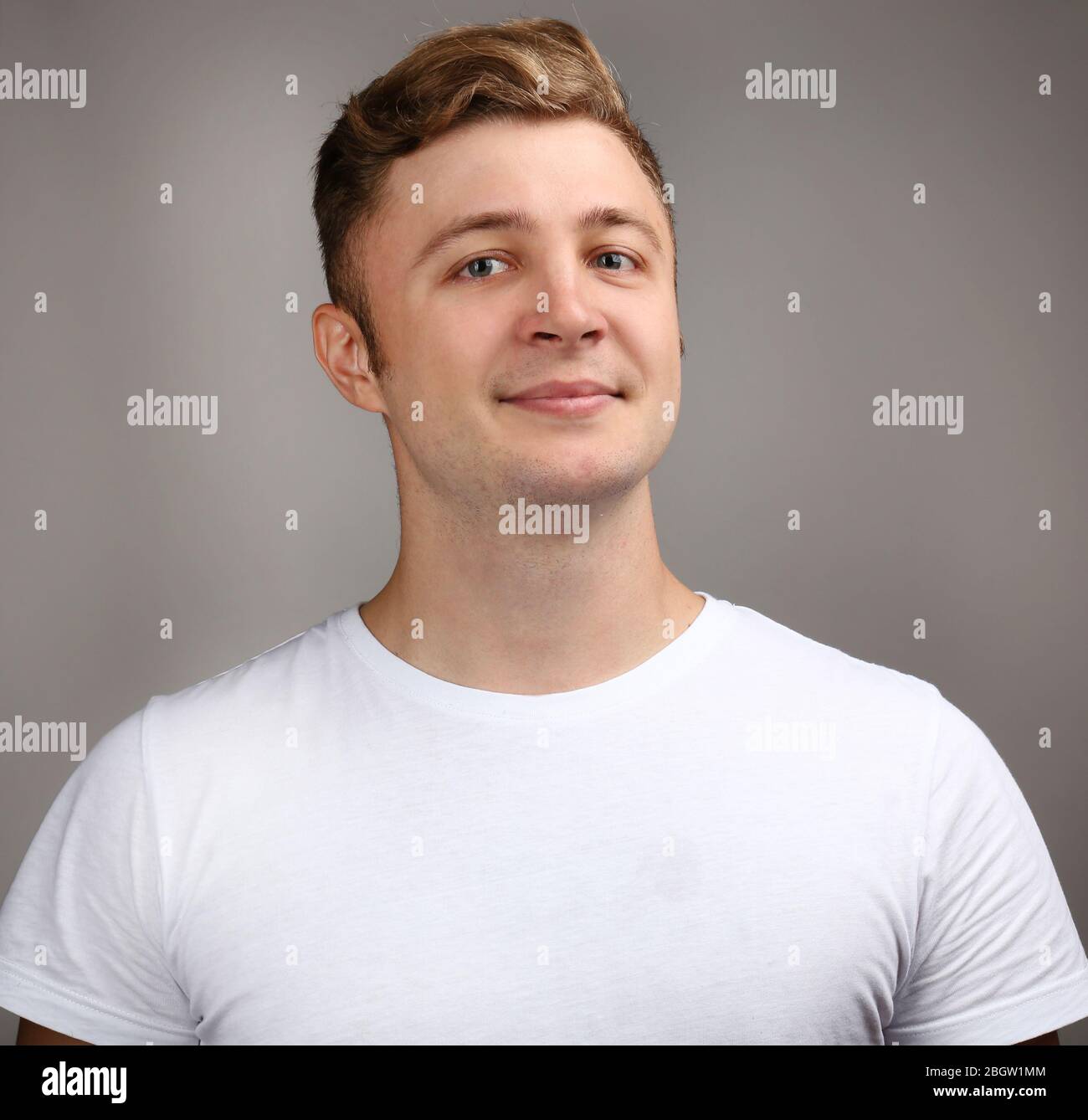 Portrait of young man on grey background Stock Photo - Alamy