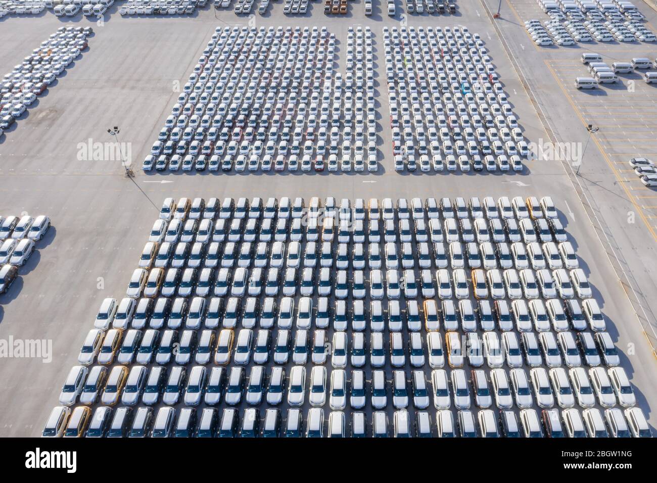 Aerial top view new cars lined up in the port for import export business logistic and transportation by ship in the open sea. New cars from the car fa Stock Photo