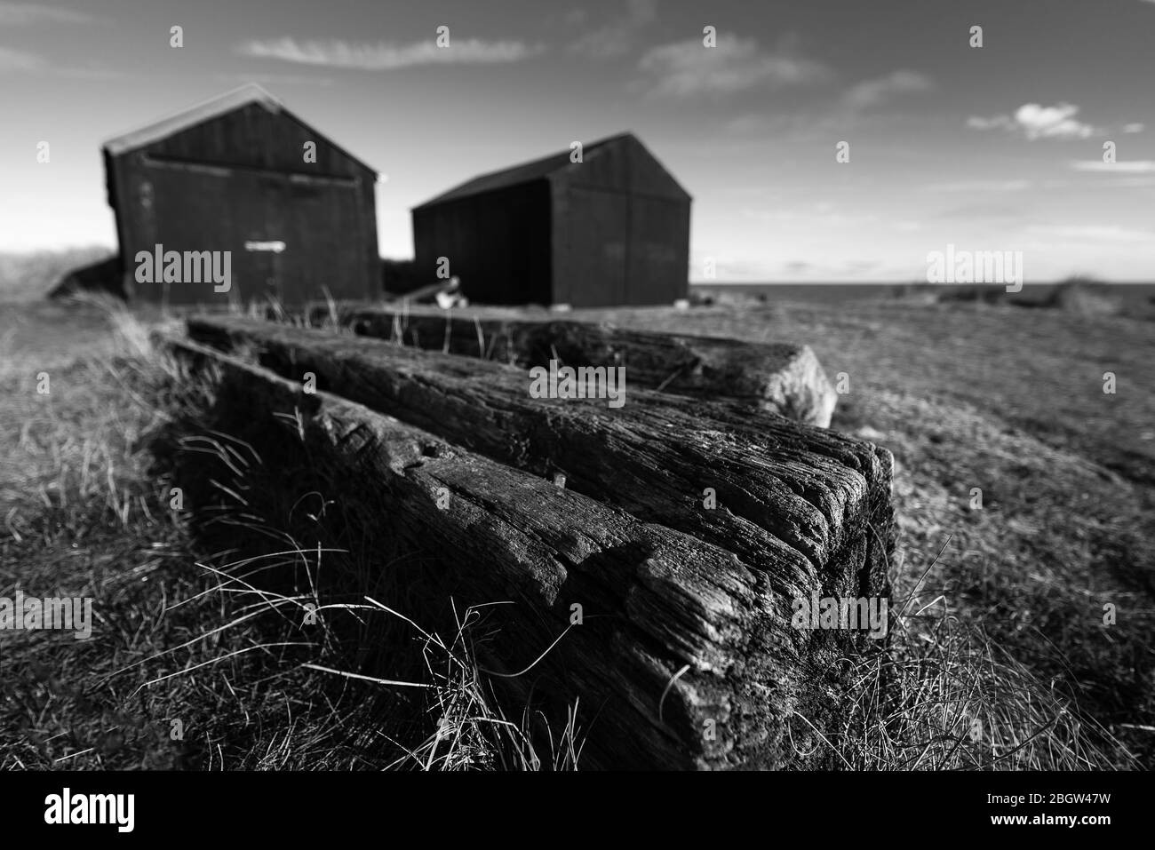 Fishermans huts with old timbers foreground ii. Mono- Winterton, November 2016 Stock Photo