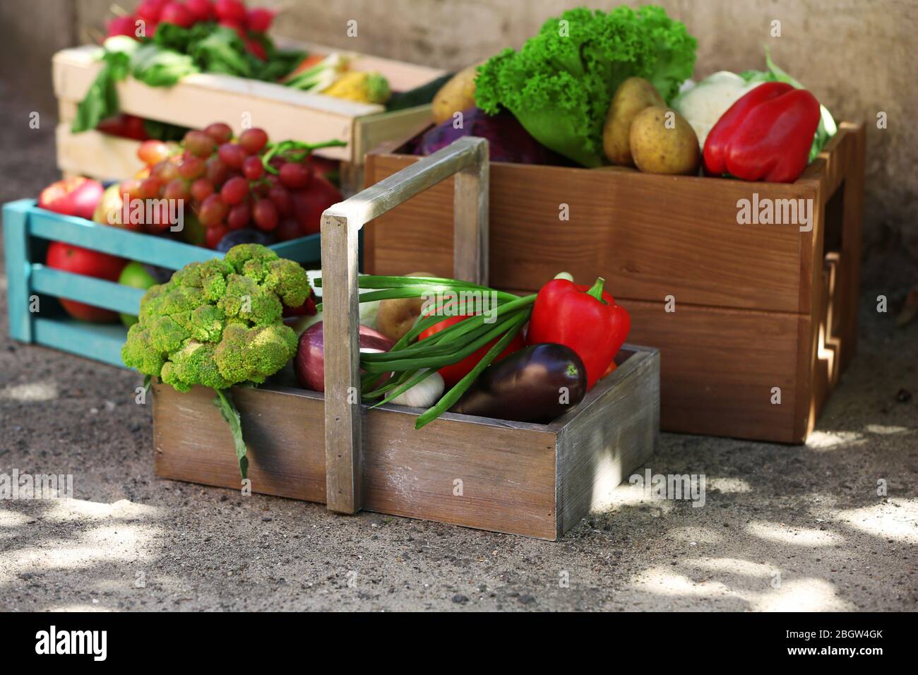 Fresh organic fruits and vegetables in wooden boxes outdoors Stock ...