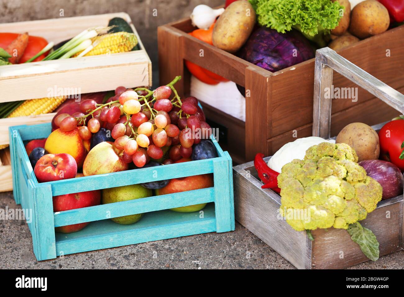 Fresh organic fruits and vegetables in wooden boxes outdoors Stock ...