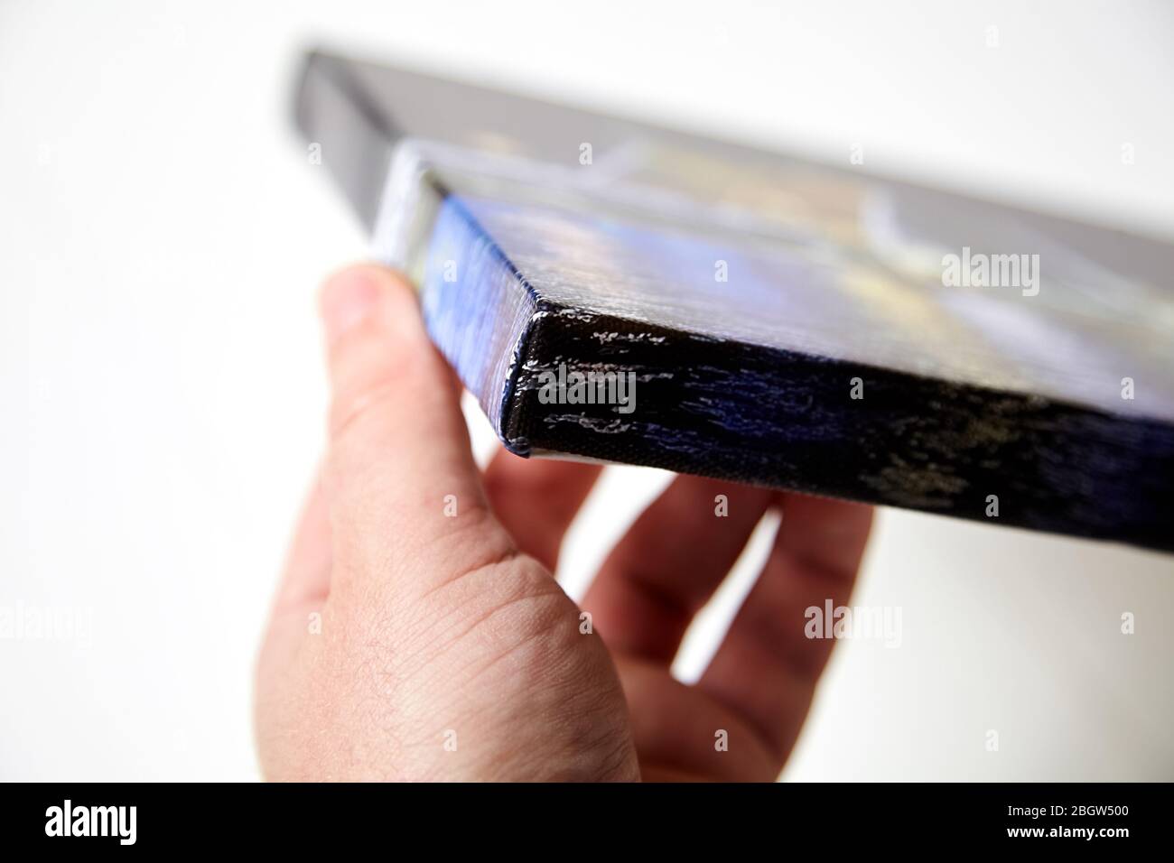 Canvas print. Hand holds a photo with gallery wrap method of canvas