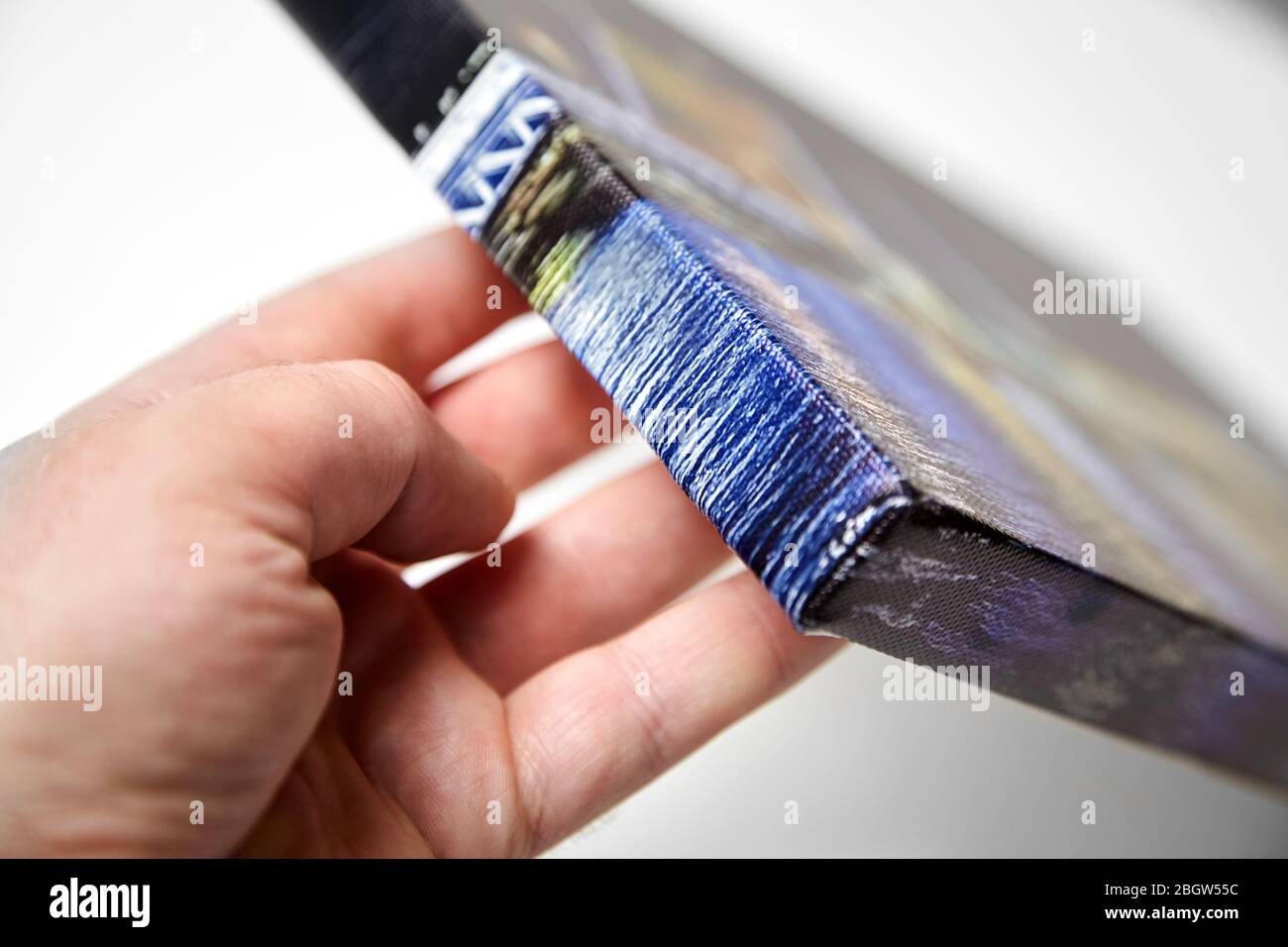 Canvas print. Hand holds a photo with gallery wrap method of canvas