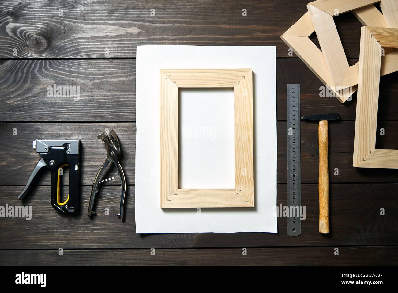 Stretching canvas on wooden stretcher bar, staple gun and canvas pliers