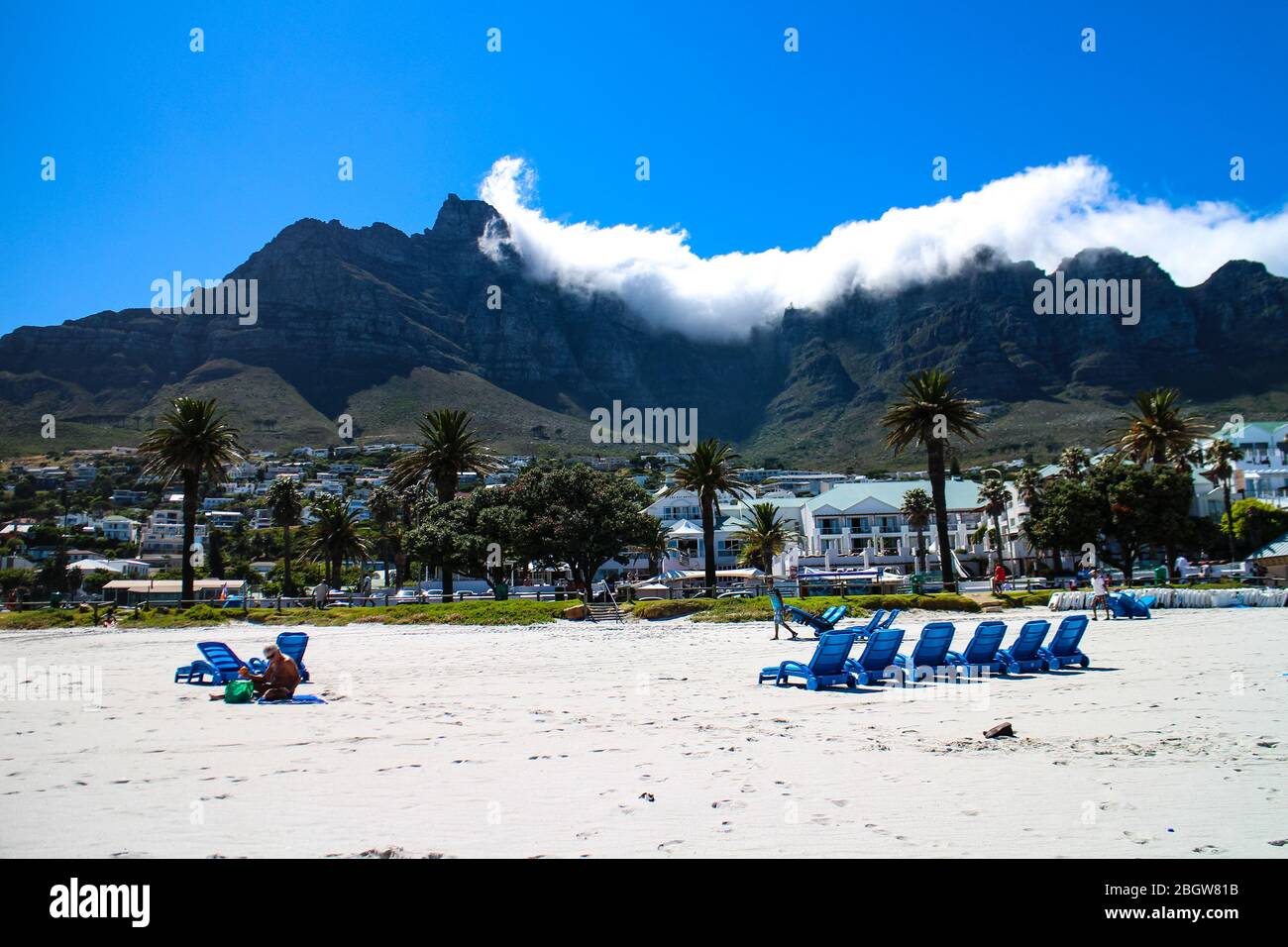 Camp's bay beach life with Table Mountain National Park mountain range in the background, Cape Town, Western Cape, South Africa. Stock Photo