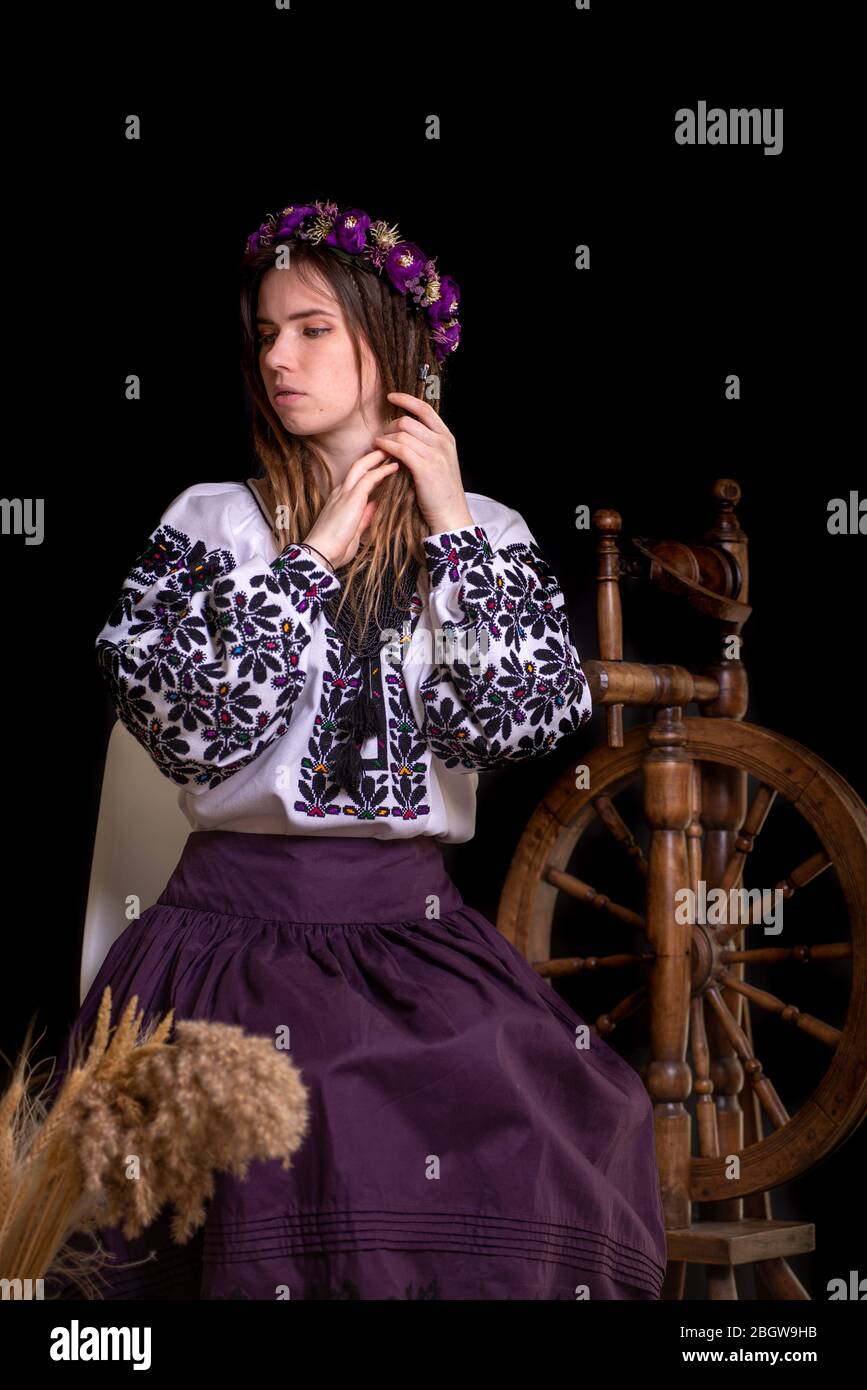 Modern Ukrainian national clothes. Portrait of a beautiful woman with dreadlocks in an embroidered national dress on a black background. Ukrainian Stock Photo