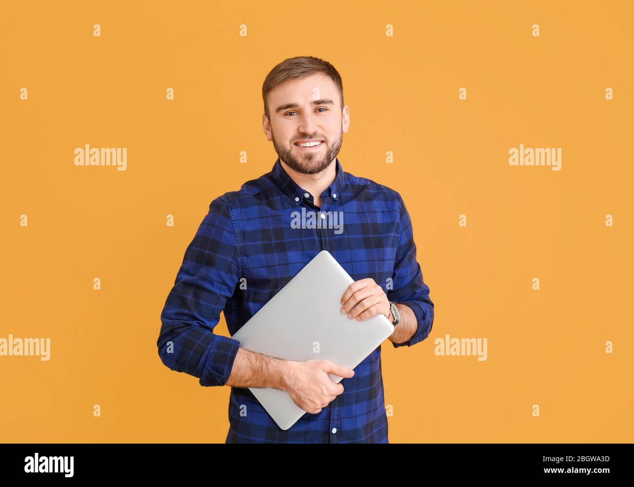 Male programmer with laptop on color background Stock Photo