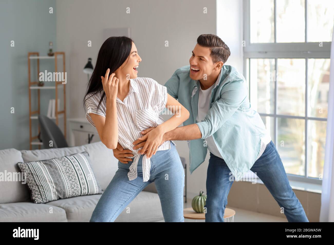 Portrait of happy young couple at home Stock Photo - Alamy
