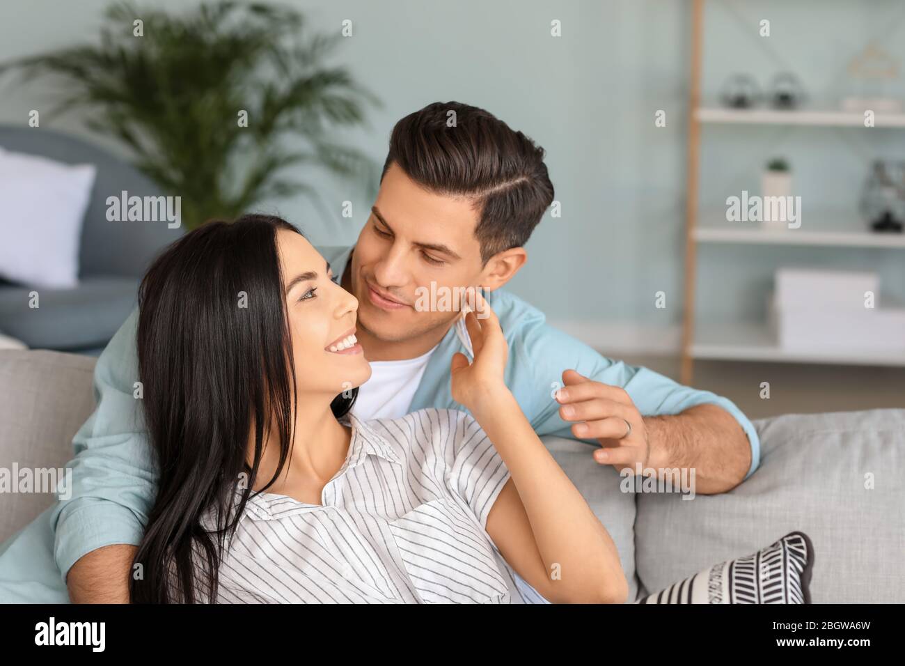 Portrait of happy young couple at home Stock Photo - Alamy