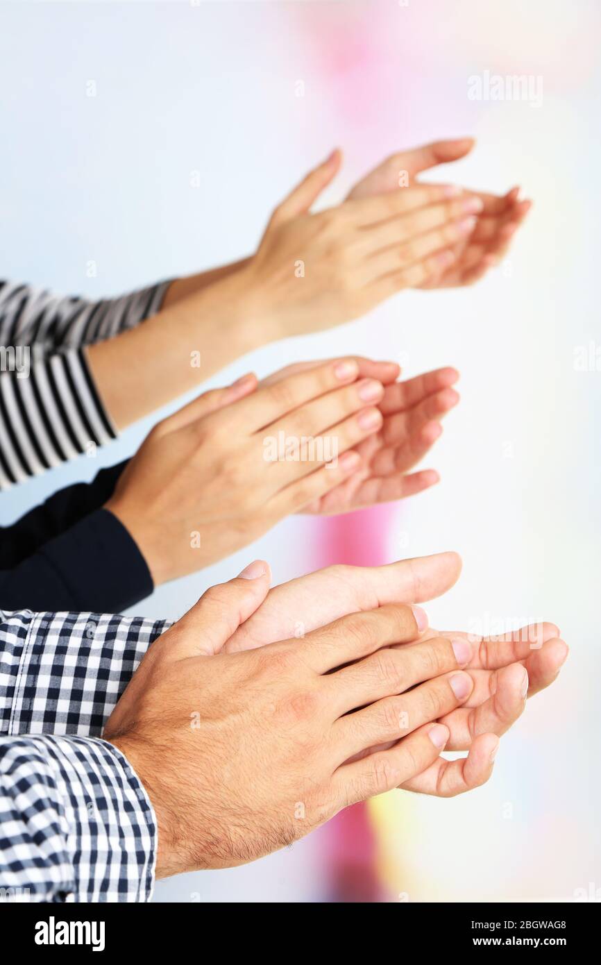 Clapping hands on bright background Stock Photo - Alamy