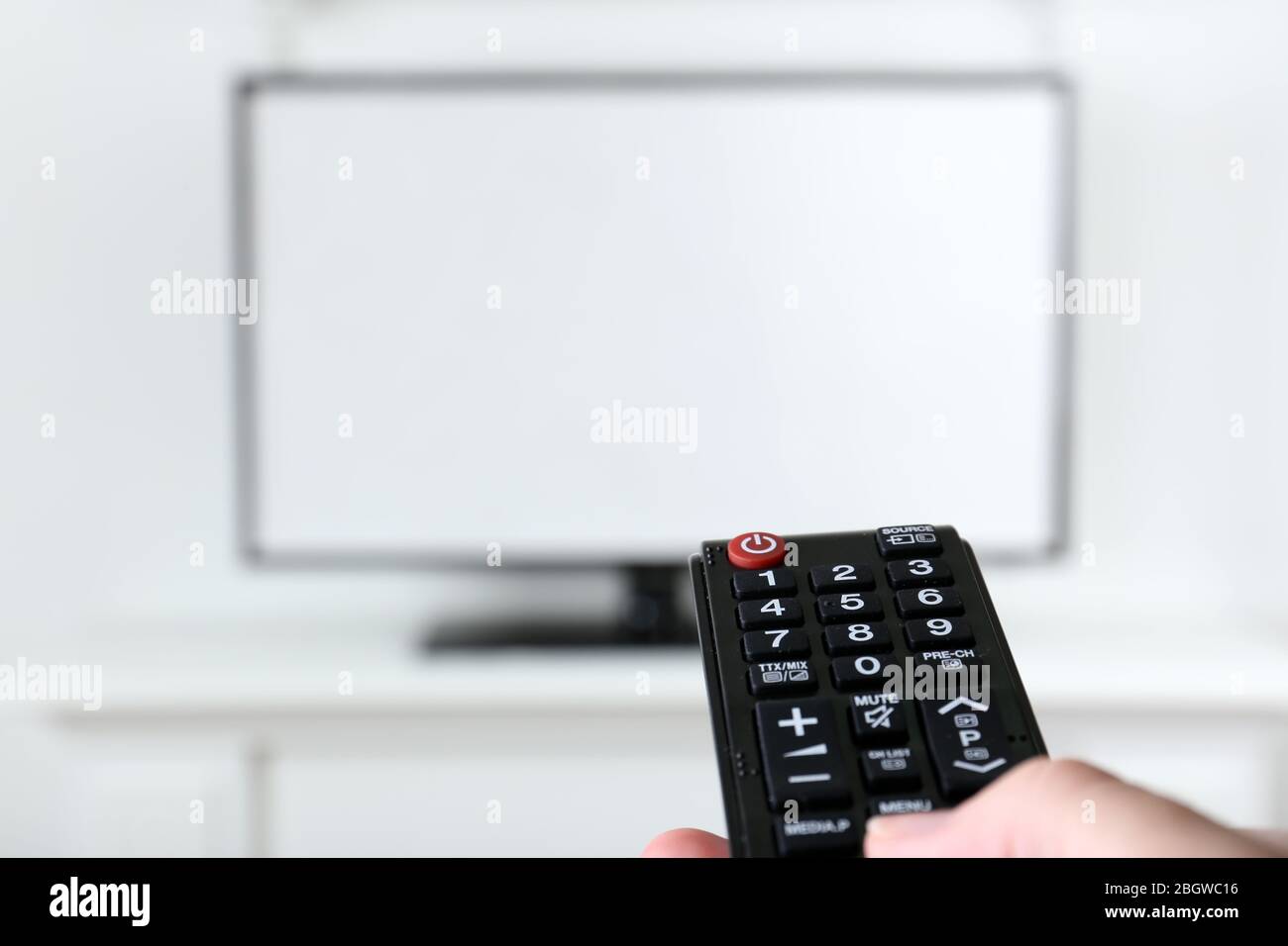 Watching tv using remote controller hi-res stock photography and images ...