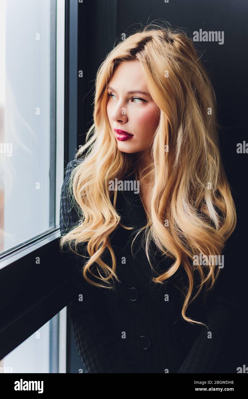 Blonde business woman in a black suit Stock Photo - Alamy