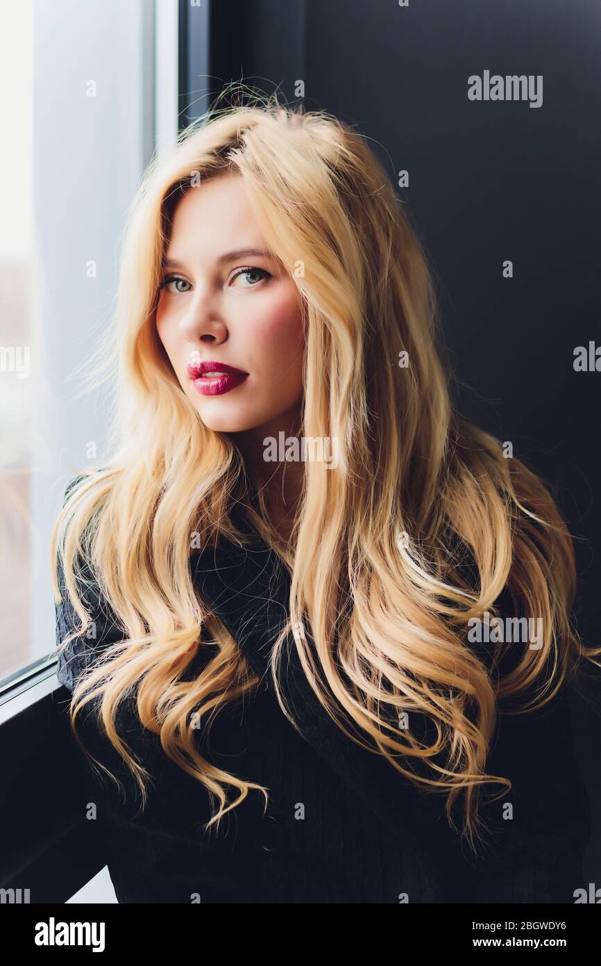 Blonde business woman in a black suit Stock Photo - Alamy